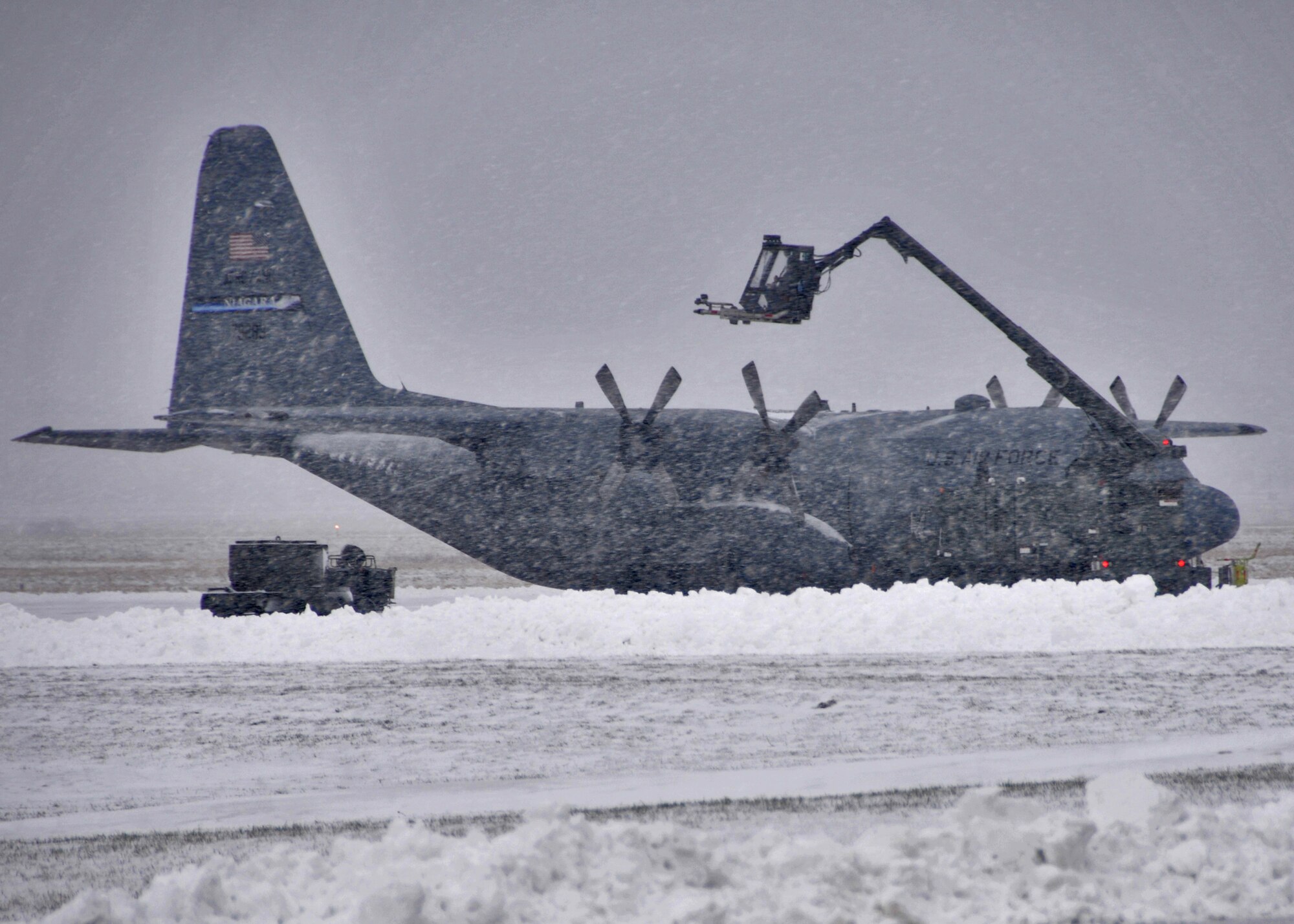 Members of the 914th Airlift Wing deice a C-130 on the flightline February 4, 2011 Niagara Falls Air Reserve Station, Niagara Falls, NY. When there are freezing conditions and precipitation, de-icing an aircraft is crucial. Frozen contaminants can make critical control surfaces rough and uneven, which can disrupt smooth air flow and greatly reduce the ability of the wing to generate lift. This situation can cause a crash. If large pieces of ice separate when the aircraft is in motion, they can be sucked into engines or damage propellers causing possible failure. Ice can jam control surfaces, preventing them from working properly. Because of this potentially severe consequence, de-icing is performed at airports where temperatures are likely to be around 0°C. (U.S. Air Force photo by Staff Sgt. Joseph McKee)