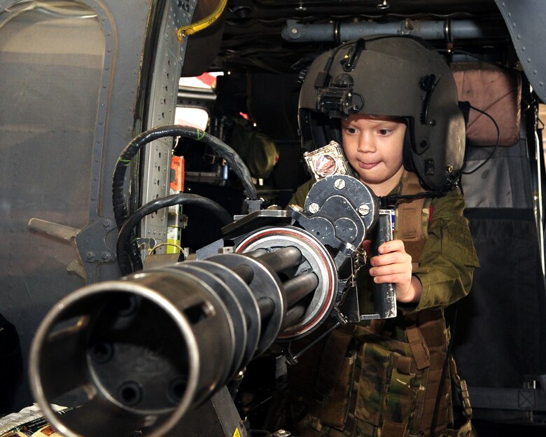 DAVIS-MONTHAN AIR FORCE BASE, Ariz. - Pilot for a Day participant Chenoa Richner, 7, sits in the aerial gunner seat of a HH-60 Pave Hawk as part of her tour of the base Dec. 29. The Pilot for a Day Program is designed to give local children with illnesses an enjoyable day completely devoted to them and their interest in aviation. (U.S. Air Force photo/Airman 1st Class Michael Washburn)
