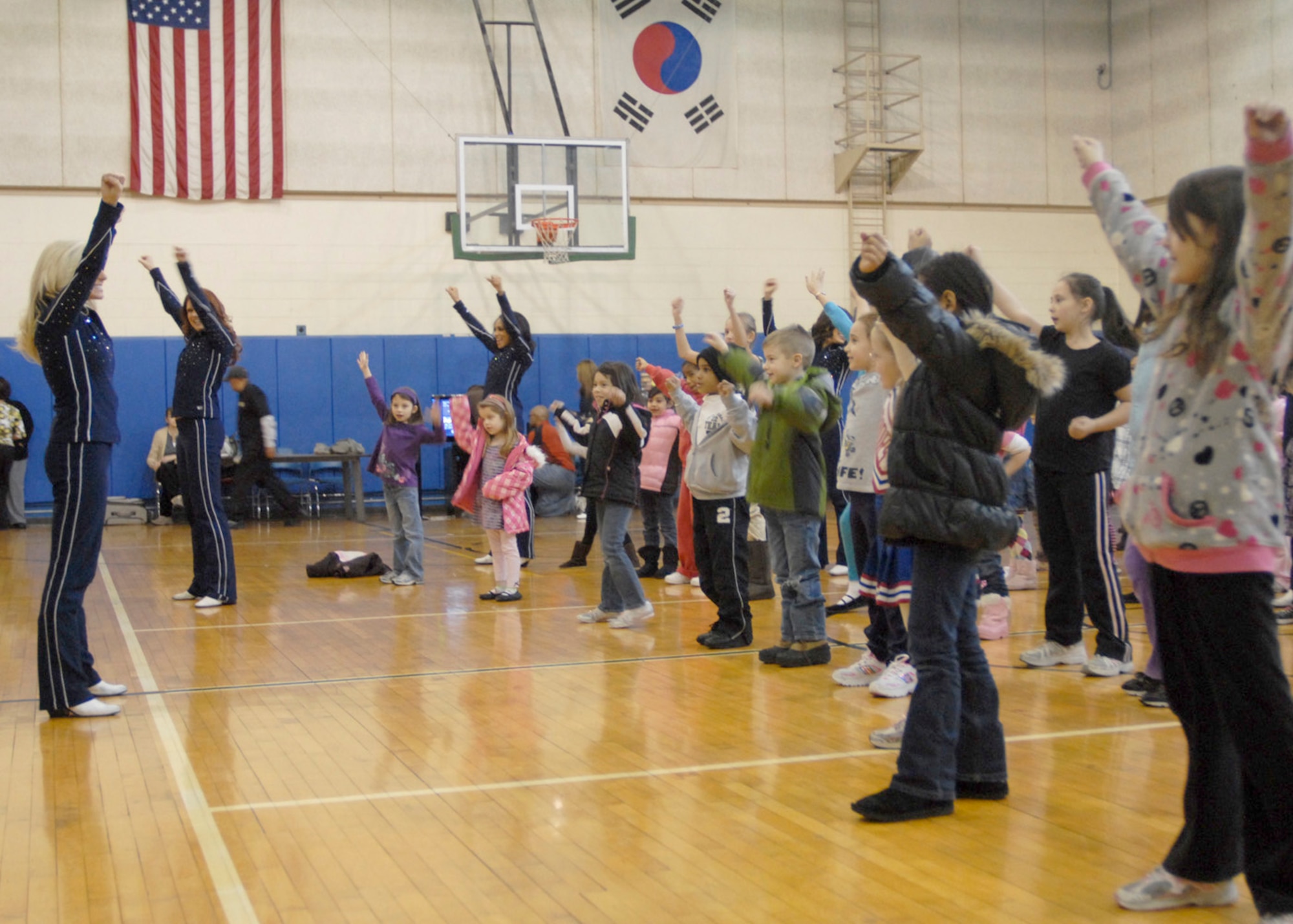 Dallas Cowboys cheerleaders participate in a free cheer clinic for family members Dec. 29, 2010, during a visit to Osan Air Base, South Korea. (U.S. Air Force photo/1st Lt. Cody Chiles)