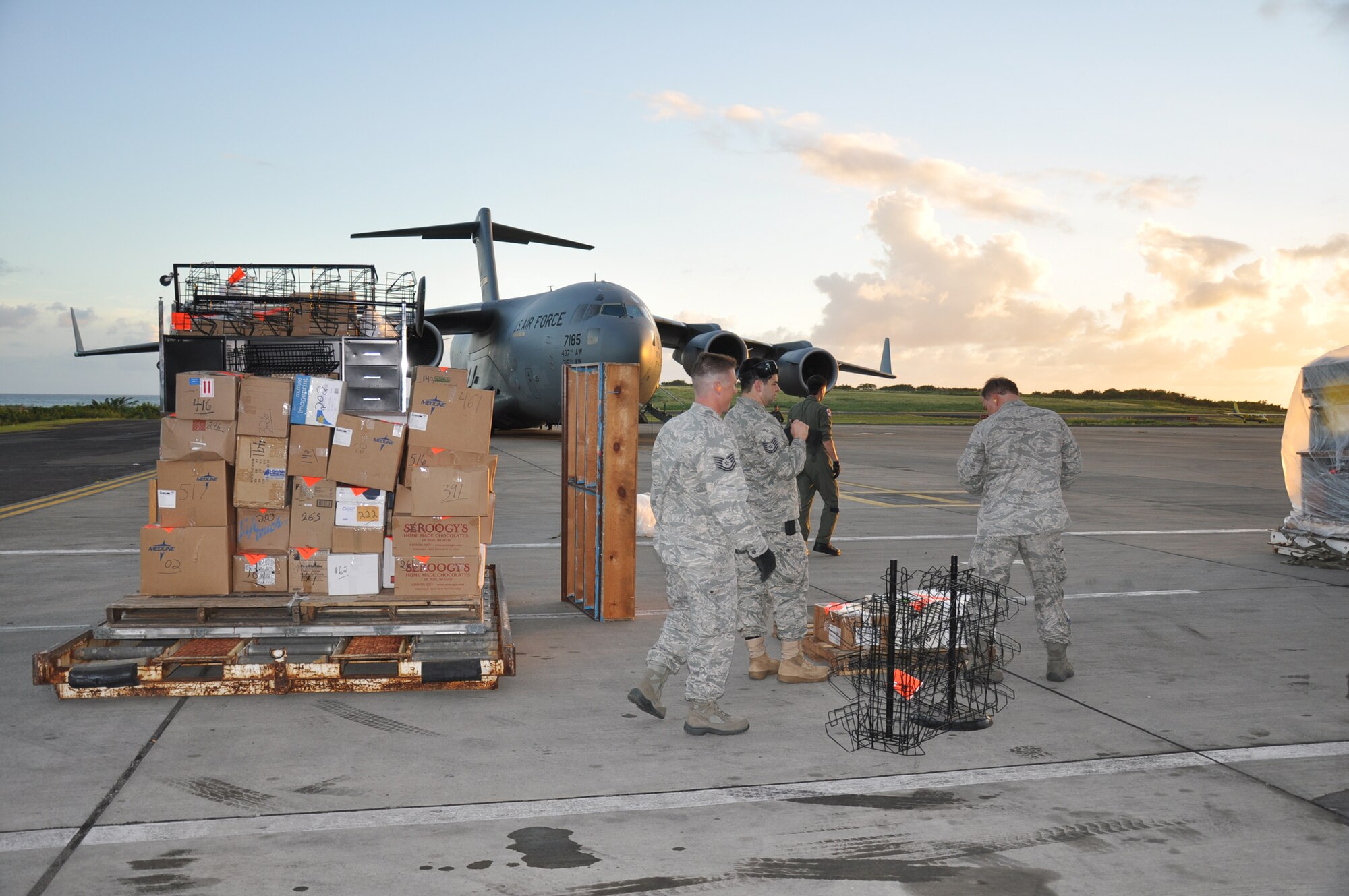 Aerial porters otherwise known as "Port Dawgs" from the 81st Aerial Port Squadron, Joint Base Charleston, S.C., breakdown much needed school and medical supplies for transport to children and their families of Grenada during a training and humanitarian mission to Haiti and Grenada Dec. 30, 2010. (U.S. Air Force photo/Senior Airman Robert Pilch) 