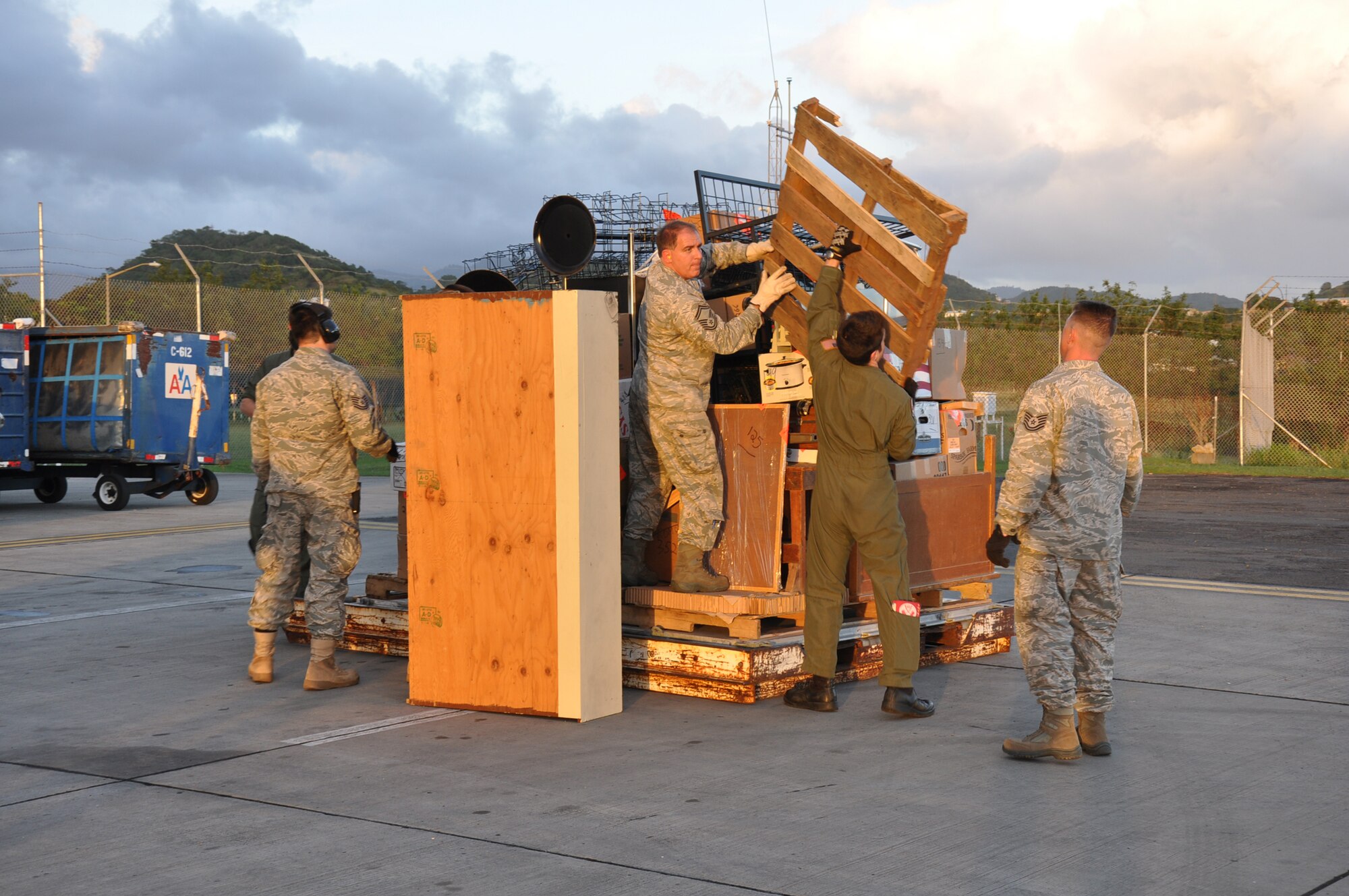 Aerial porters otherwise known as "Port Dawgs" from the 81st Aerial Port Squadron, Joint Base Charleston, S.C., breakdown much needed school and medical supplies for transport to children and the people of Grenada during a training and humanitarian mission to Haiti and Grenada Dec. 30, 2010. (U.S. Air Force photo/Senior Airman Robert Pilch)
