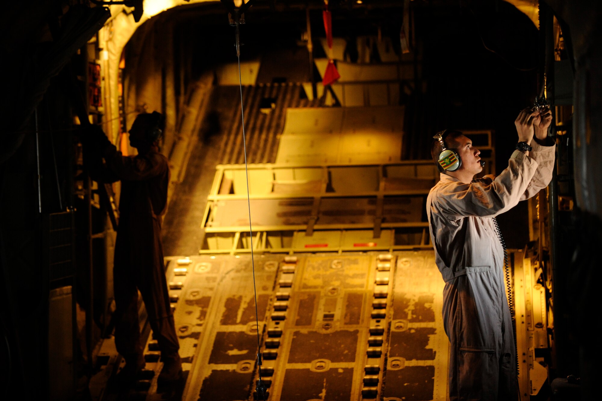 U.S. Air Force Senior Airman Jason Ignacio (right), 772nd Expeditionary Airlift Squadron, and Tech. Sgt. Brian Digsby (left) conduct post-drop procedures aboard a C-130J Hercules after dropping pallets in support of Operation Enduring Freedom while flying over Afghanistan, Dec. 29, 2010.  C-130 aircrews ensure that troops on the ground have adequate supplies to complete their mission.  (U.S. Air Force Photo/Staff Sgt. Eric Harris) (RELEASED)
