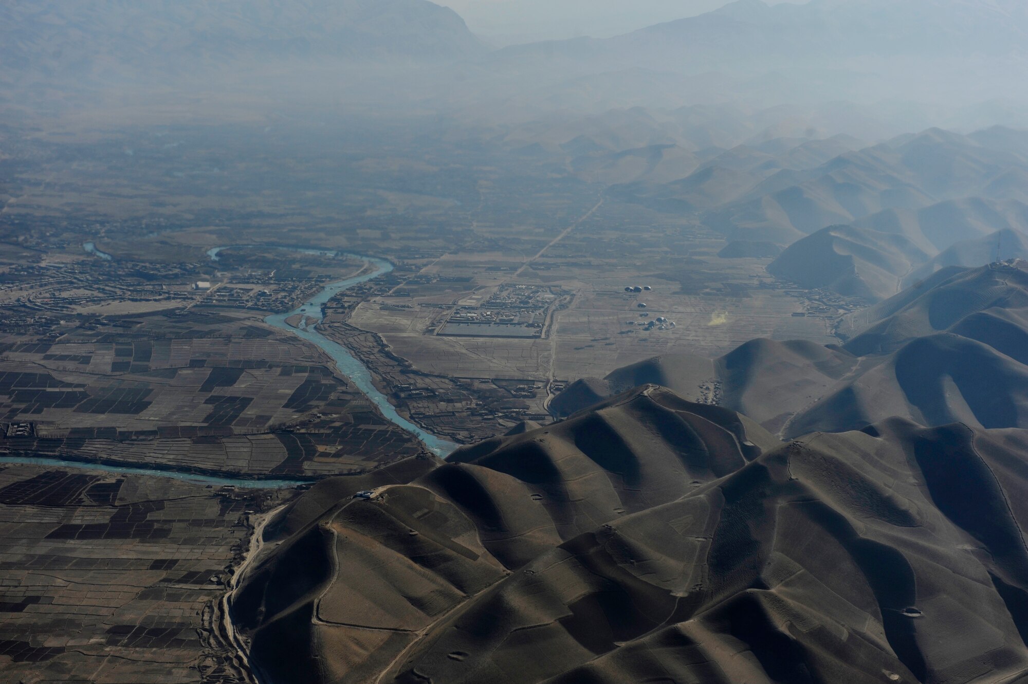 Container delivery system (CDS) bundles float to the ground after being dropped from a U.S. Air Force C-130J Hercules flying over Afghanistan in support of Operation Enduring Freedom, Dec. 29, 2010.  C-130 aircrews ensure that troops on the ground have adequate supplies to complete their mission.  (U.S. Air Force Photo/Staff Sgt. Eric Harris) (RELEASED)