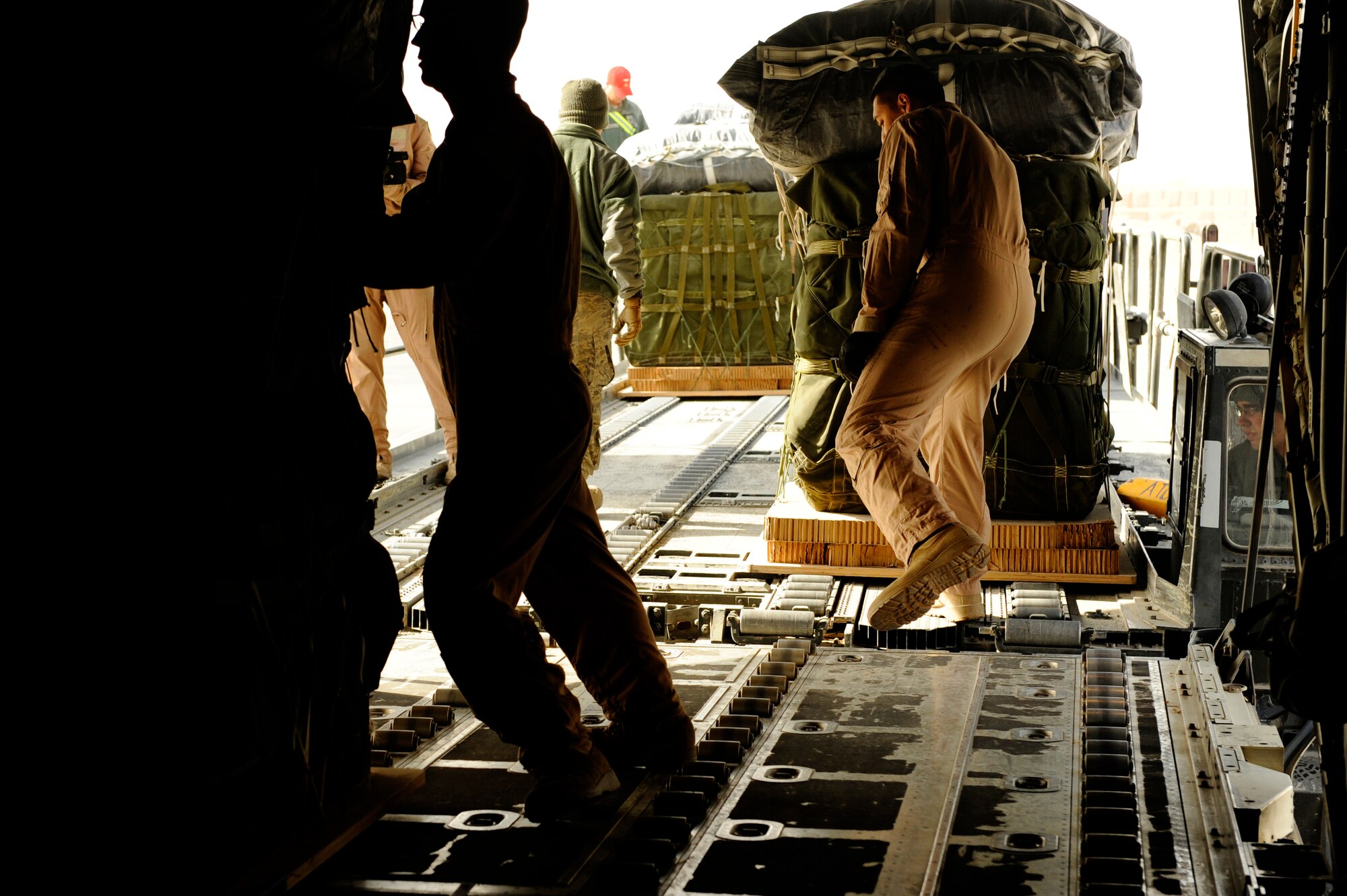 U.S. Air Force Senior Airman Jason Ignacio, 772nd Expeditionary Airlift Squadron, loads pallets onto a C-130J Hercules before an air drop mission in support of Operation Enduring Freedom at Kandahar Airfield, Afghanistan, Dec. 29, 2010.  C-130 aircrews ensure that troops on the ground have adequate supplies to complete their mission.  (U.S. Air Force Photo/Staff Sgt. Eric Harris) (RELEASED)