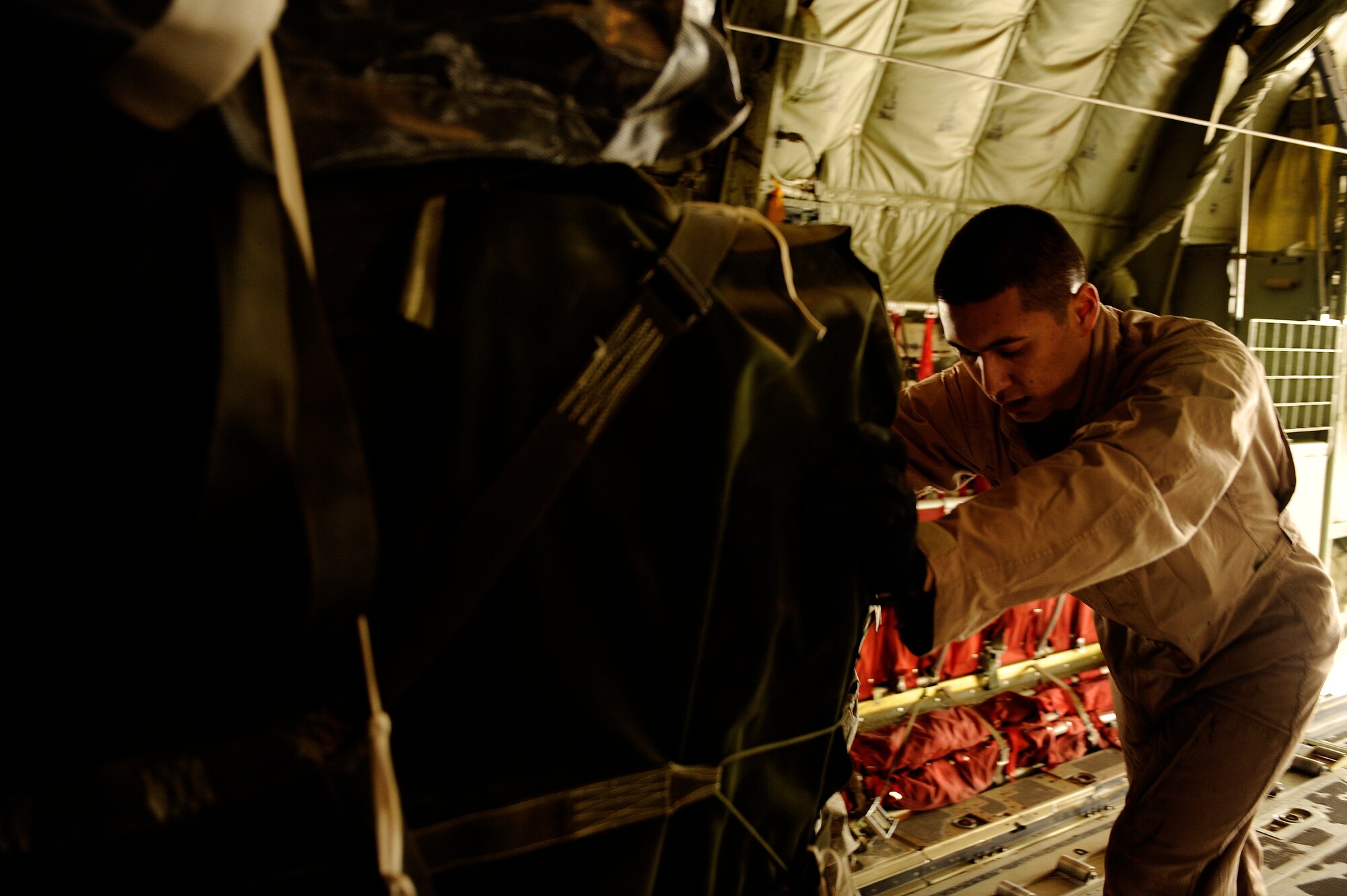 U.S. Air Force Senior Airman Jason Ignacio, 772nd Expeditionary Airlift Squadron, loads pallets onto a C-130J Hercules before an air drop mission in support of Operation Enduring Freedom at Kandahar Airfield, Afghanistan, Dec. 29, 2010.  C-130 aircrews ensure that troops on the ground have adequate supplies to complete their mission.  (U.S. Air Force Photo/Staff Sgt. Eric Harris) (RELEASED)
