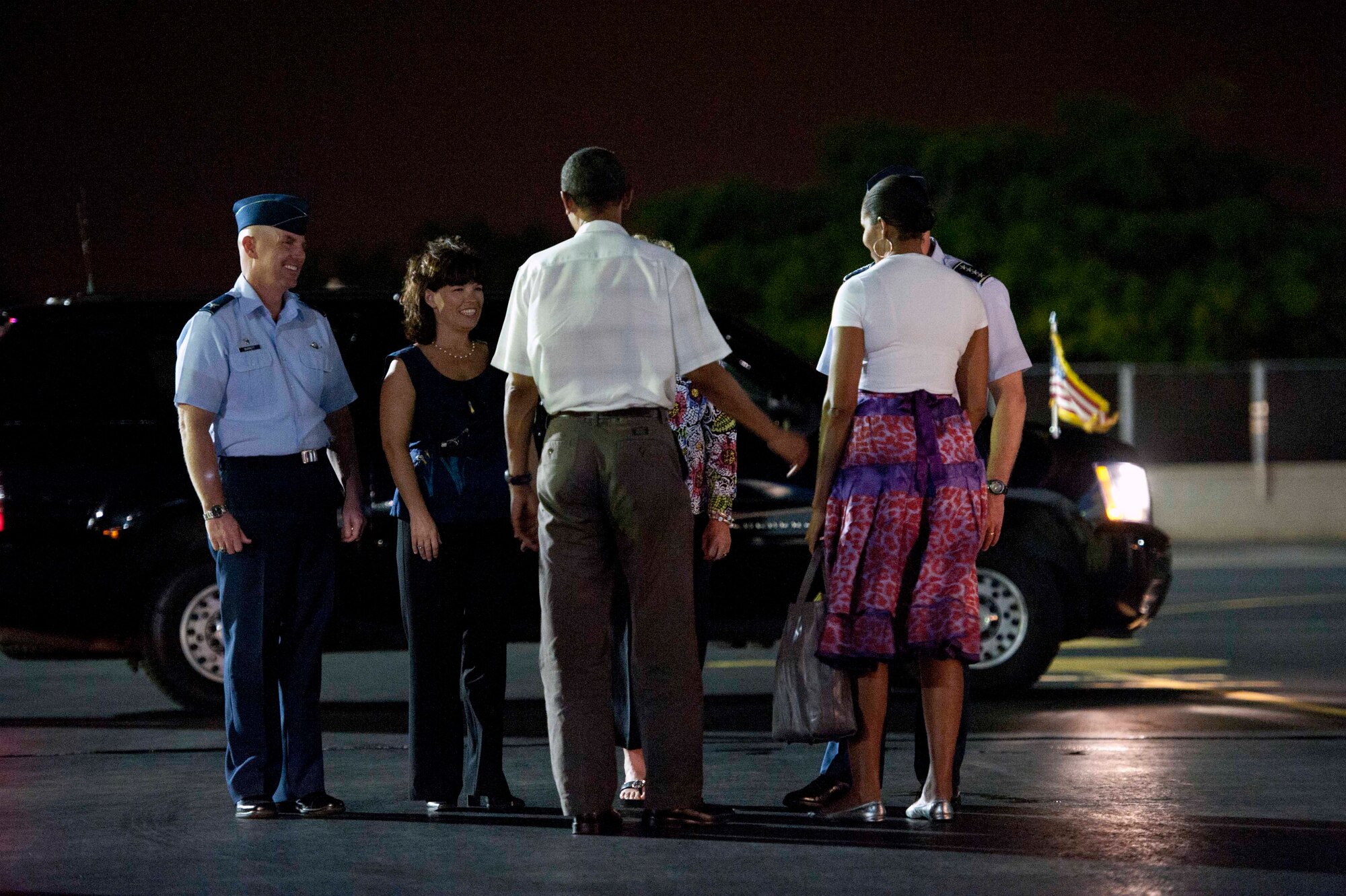 President Barack Obama and his wife Michelle talk with Gen. Gary North, Pacific Air Forces commander, and his wife Shelley, and  Col. Sam Barrett, 15th Wing commander, and his wife Kelly,  as the President and first family prepare to depart the 15th Wing at Joint Base Pearl-Harbor Hickam, Hawaii, Jan. 3. The President arrived on Dec. 22, and Air Force One remained parked at the 15th Wing while the President vacationed in Hawaii with his family. (U.S. Air Force photo/Staff Sgt. Nathan Allen)