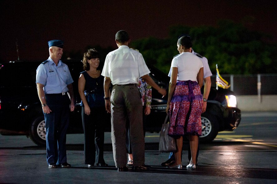 President Barack Obama and his wife Michelle talk with Gen. Gary North, Pacific Air Forces commander, and his wife Shelley, and  Col. Sam Barrett, 15th Wing commander, and his wife Kelly,  as the President and first family prepare to depart the 15th Wing at Joint Base Pearl-Harbor Hickam, Hawaii, Jan. 3. The President arrived on Dec. 22, and Air Force One remained parked at the 15th Wing while the President vacationed in Hawaii with his family. (U.S. Air Force photo/Staff Sgt. Nathan Allen)