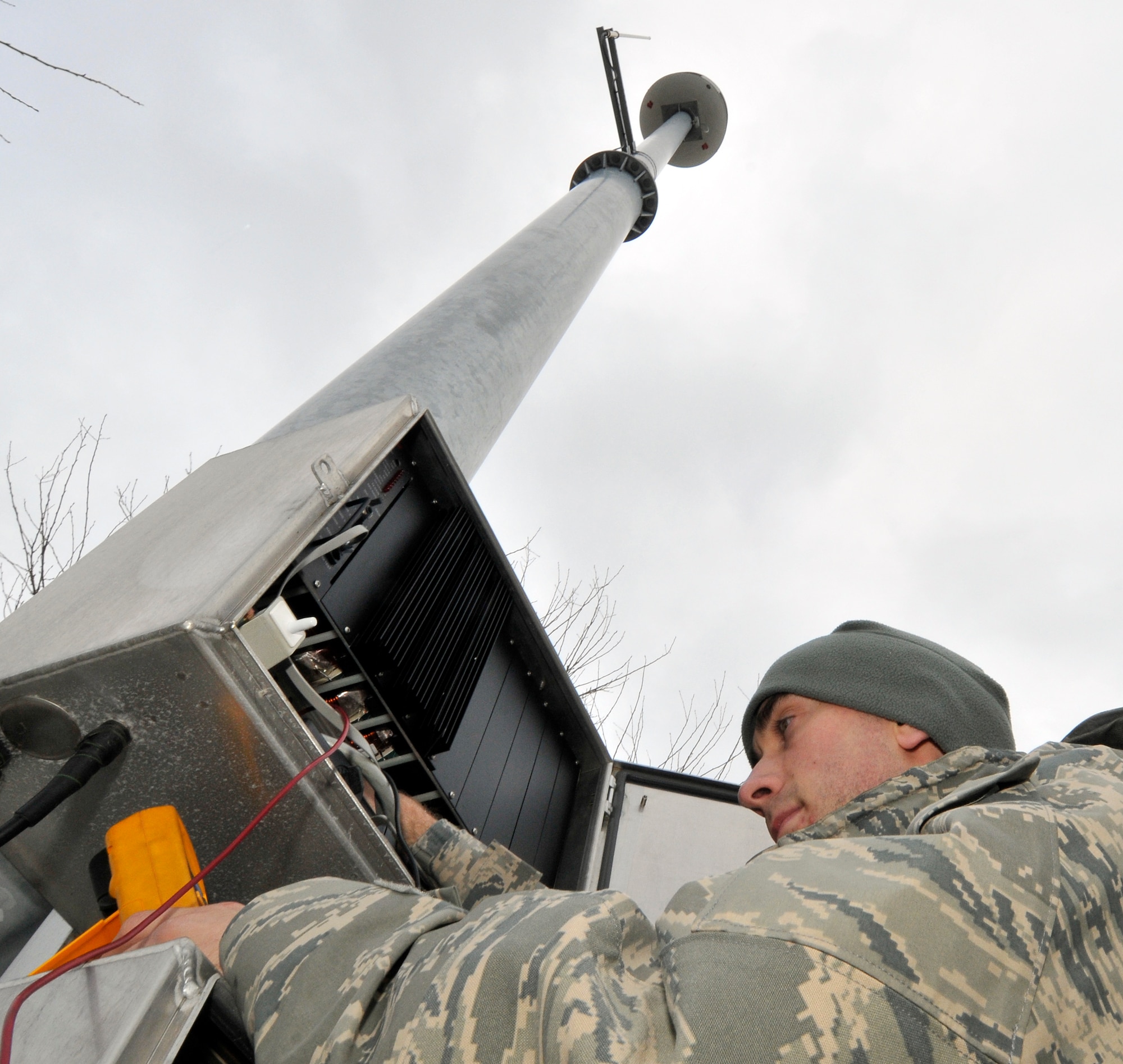 U.S. Air Force Senior Airman Cory Littlefield, 35th Communications Squadron, radio frequency transmission systems technician, measures voltage from the batteries to the radio in one of the base's mass notification system poles Dec. 4, 2010; Misawa Air Base, Japan. The giant voice system provides base-wide mass notification and alert warning to more than 13,000 residents and workers. (U.S. Air Force photo by Tech. Sgt. Phillip Butterfield/Released)