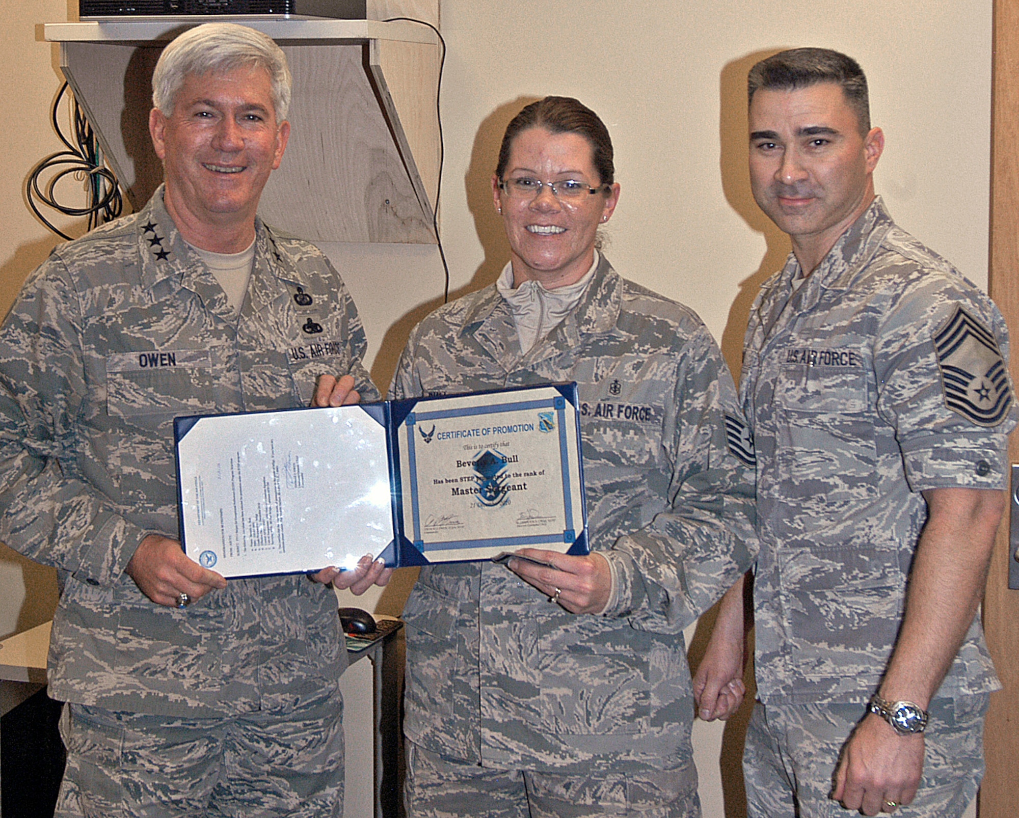 Lt. Gen. Thomas Owen and Chief Master Sgt. Edward Pace congratulate Tech. Sgt. Beverly Bull following her surprise promotion to Master Sergeant Dec. 21, 2010 at Wright-Patterson Air Force Base, Ohio.  General Owen promoted Sergeant Bull via the Stripes for Exceptional Performers program. Sergeant Bull is Pediatric Flight chief with the 88th Medical Operations Squadron.  General Owen is commander of Aeronautical Systems Center and Chief Pace is superintendent of the 88th Medical Group and acting command chief for ASC and the 88th Air Base Wing. (U.S. Air Force photo/Derek Kaufman) 