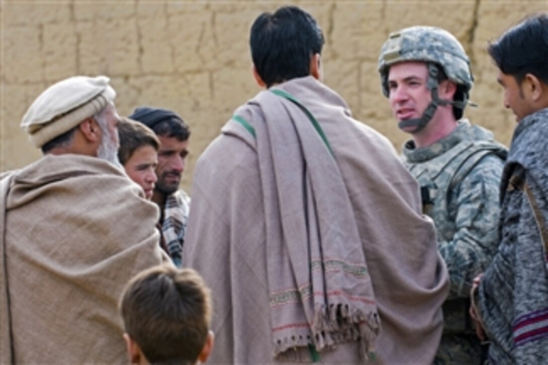 U.S. Air Force Capt. Seth Platt meets with locals during a site survey for the proposed Abdul Hadi Padar secondary school in the Nijrab valley of Kapisa province, Afghanistan, on Dec. 29, 2010.  Platt is a civil engineer assigned to the Kapisa Provincial Reconstruction Team.  This site survey was conducted with local officials and community leaders.  