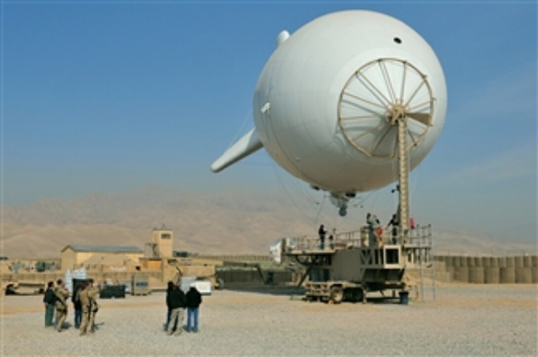 A persistent surveillance system launches from Forward Operating Base Khilegay, Afghanistan, on Dec. 30, 2010.  The persistent surveillance system consists of an aerostat, also called a blimp, and mounted camera equipment capable of high-resolution imagery and high-quality video that provides instant situational awareness throughout the region.  