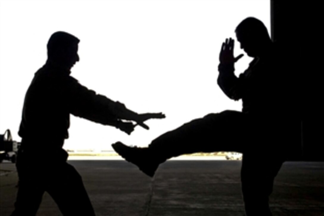 A member of the Iraqi air force, left, defends himself against U.S. Air Force Staff Sgt. Timothy DeTerra during a training session on New Al-Muthana Air Base, Iraq, Dec. 23, 2010. This training is the first of its kind at the base, and promises to help the Iraqi air force build a reliable and secure force in the year ahead. DeTerra is a base transition team member.