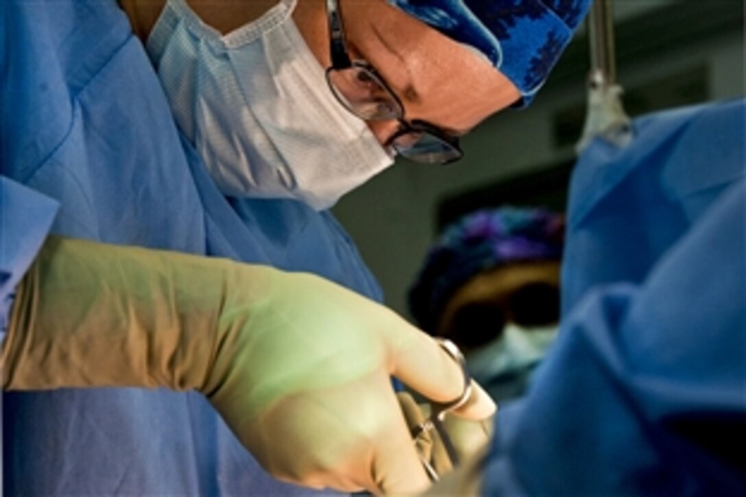 U.S. Navy Lt. Cmdr. Kimberly Syres performs a laparoscopic appendectomy in the operating room aboard the aircraft carrier USS Carl Vinson in the Pacific Ocean, Dec. 31, 2010. The Carl Vinson and Carrier Air Wing17 are deployed to the U.S. 7th Fleet area of responsibility.