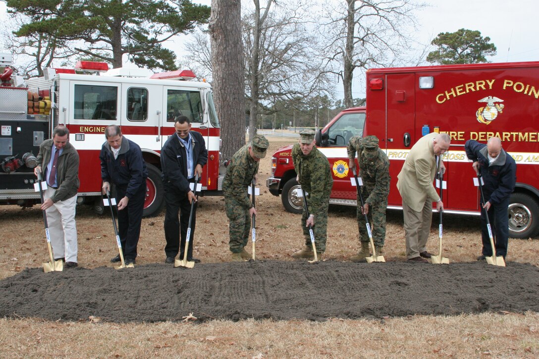 From left to right, retired Fire Chief Thomas C. Mylett, Chief Kenneth R. Lavoie, Fitz Chavis, Cherry Point’s commanding officer Col. Philip J. Zimmerman, Lt. Col. Brian E. Kuhn, Maj. Terrence Fox, Chris Newton and Assistant Chief James P. Johnson officially break ground at the new fire station facility location, Jan. 5. The new facility will replace Fire Station 4 in the Lanham housing area and bring the fire station up to modern standards.