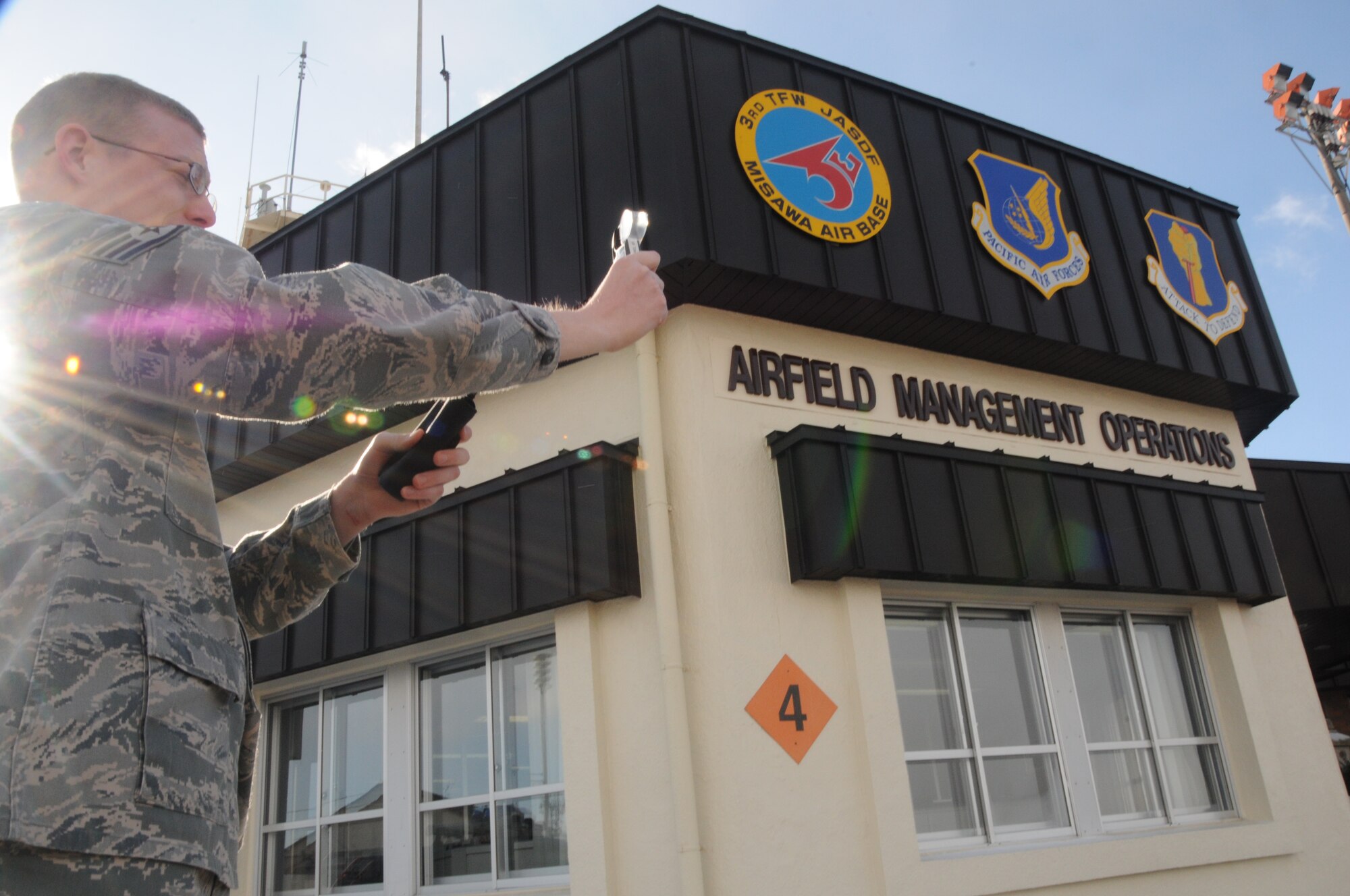 U.S. Air Force Staff Sgt. Brandon Knight, 35th Operations Support Squadron weather forecaster, reviews a Kestrel 4000 for current weather conditions at Misawa Air Base, Japan; Jan. 6, 2011. The Kestrel 4000 is a weather device that identifies temperature, humidity, air pressure and wind speed. (U.S. Air Force photo by 1st Lt. Cammie Quinn/Released)