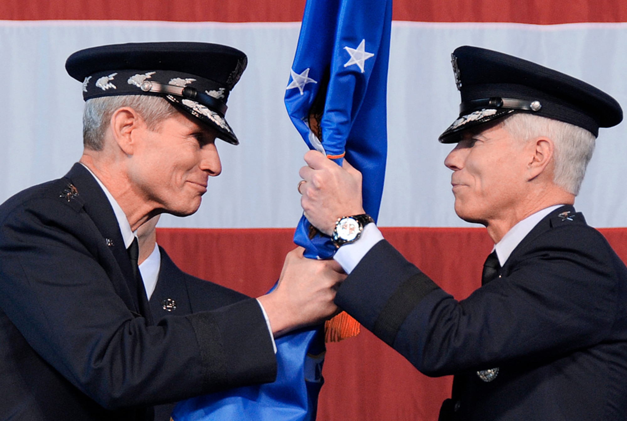 Air Force Chief of Staff Gen. Norton Schwartz (left) hands the Air Force Space Command flag to Gen. William L. Shelton (right), as General Shelton becomes the 15th commander of AFSPC in a ceremony Jan. 5, 2011, at Peterson Air Force Base, Colo. (U.S. Air Force photo/Duncan Wood)