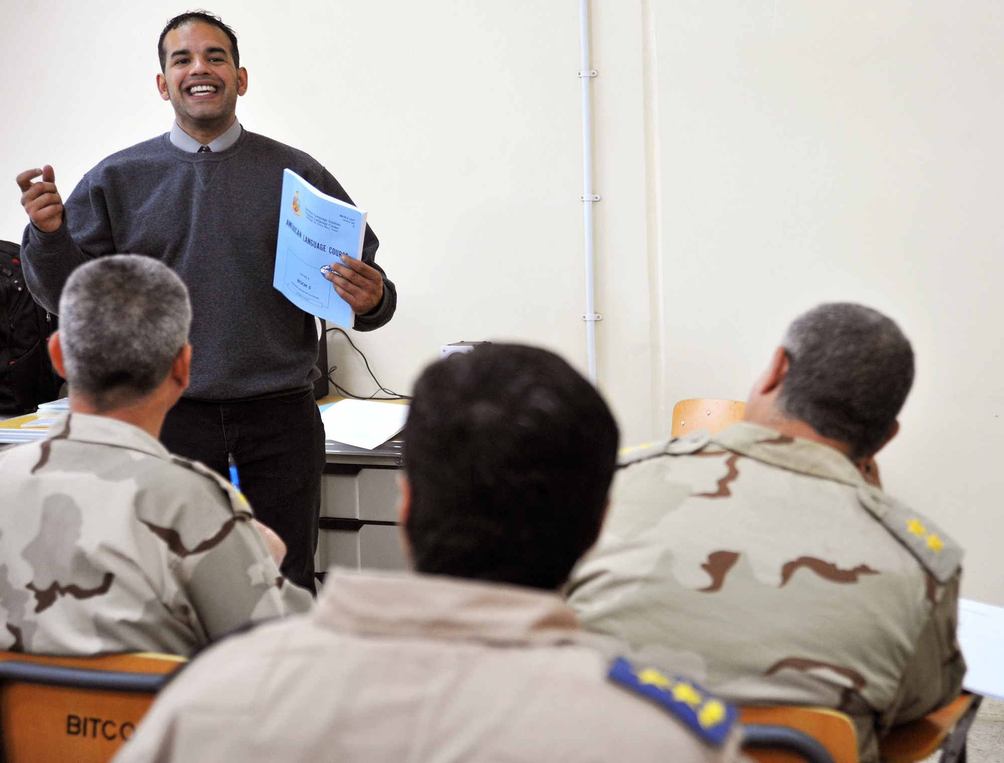 Joe Montalvo teaches a basic English language course to a class of Iraqi airmen Dec. 13, 2010, in Taji, Iraq. While air advisers work with the faculty to help them improve the way the overall program is run, it is the 19 U.S. contractors and lone Defense Language Institute civilian who work face-to-face with the students. Mr. Montalvo is an instructor at the Iraqi Air Force Training School. (U.S. Air Force photo/Senior Airman Andrew Lee)
