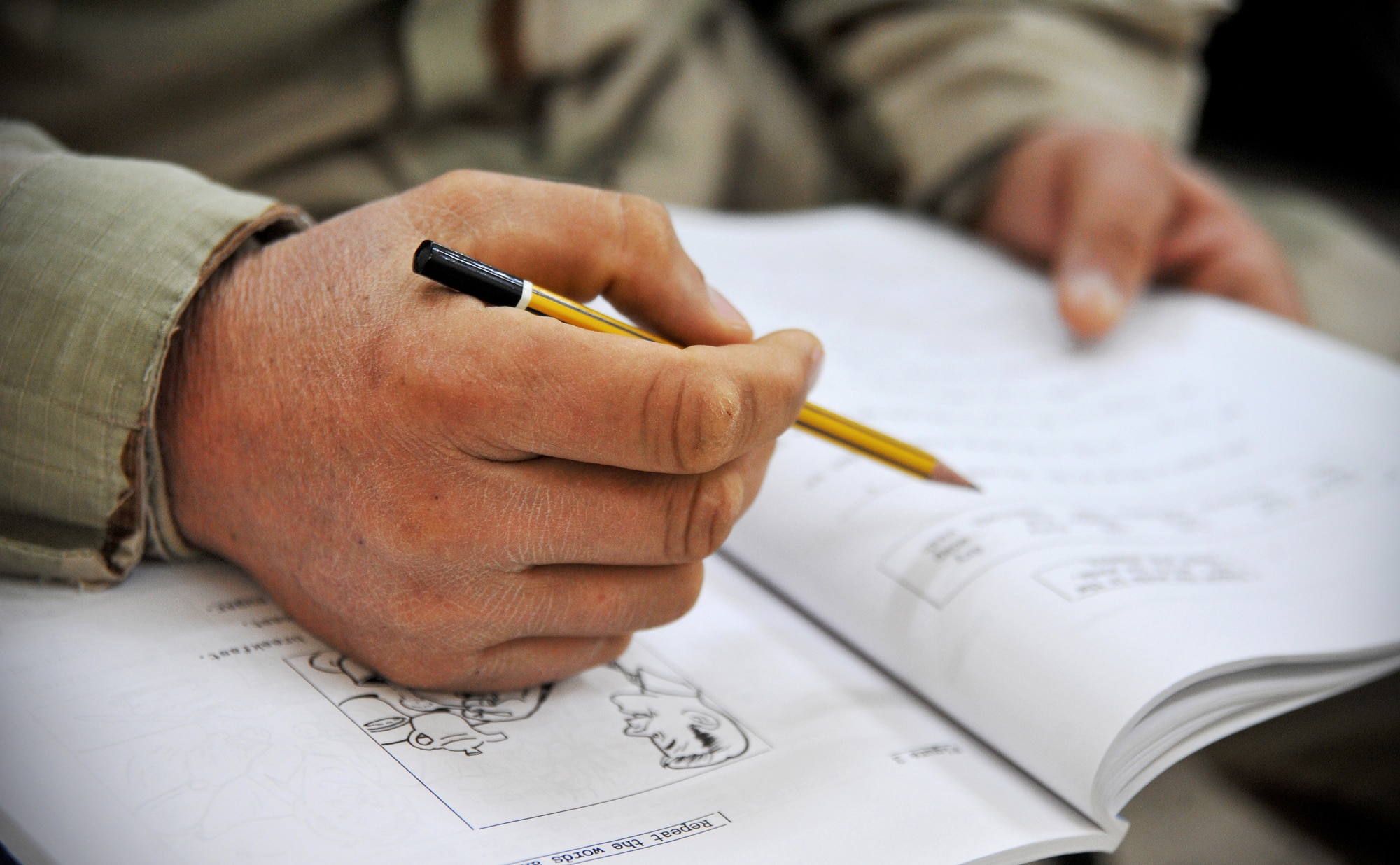 An Iraqi air force airman fills in the blanks of a test booklet during an English language class at the Iraqi Air Force Training School Dec. 13, 2010, in Taji, Iraq. The English language training is based on the Defense Language Institutes' program for teaching the English language. (U.S. Air Force photo/Senior Airman Andrew Lee)
