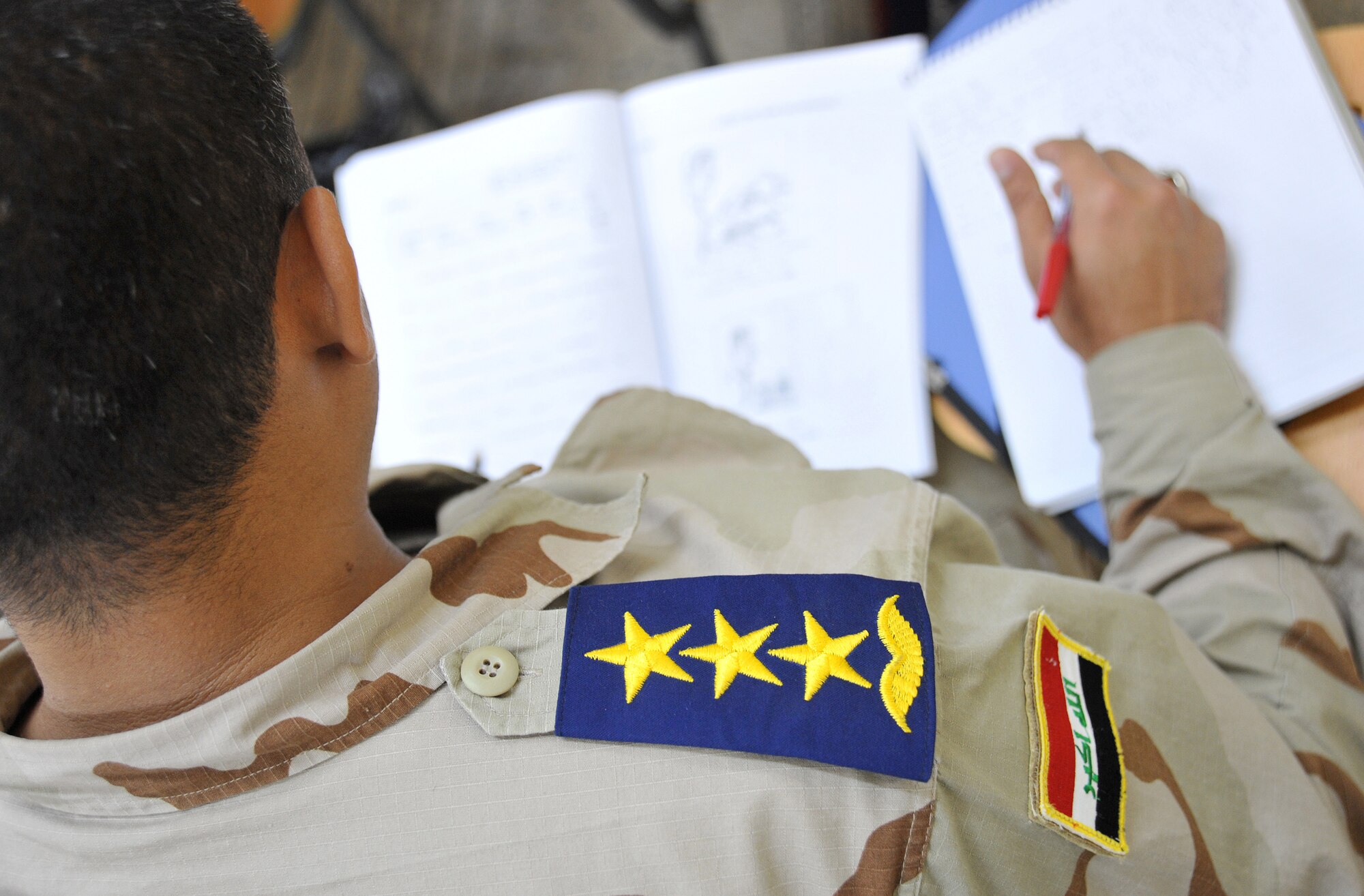 An Iraqi air force captain looks over a test booklet during an English language class at the Iraqi Air Force Training School Dec. 13, 2010, in Taji, Iraq. To date, 28 students have completed the training, which takes up to 12 months to complete. (U.S. Air Force photo/Senior Airman Andrew Lee)
