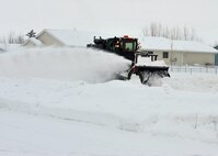 MINOT AIR FORCE BASE, N.D. -- Members from the 5th Civil Engineer Squadron, remove excess snow from the streets in base housing here Jan. 5. Snow removal is key to transportation safety on base and in the local area. (U.S. Air Force photo /Senior Airman Michael J.Veloz)