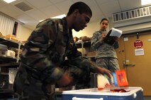 MINOT AIR FORCE BASE, N.D.-- Senior Airman Jerome Louis and Senior Airman Destiny Bellamy, both 91st Operations Support Squadron, mission support clerks prepare a food shipment for the missile fields here Jan. 5. The missile feeding operations section was one of the key areas to the 91st Operations Group bringing home the 2011 John L. Hennessy Missile Food Service Award for their excellent food service program provided to missile alert facilities.  (U.S. Air Force photo/Tech. Sgt. Lee A. Osberry Jr.)