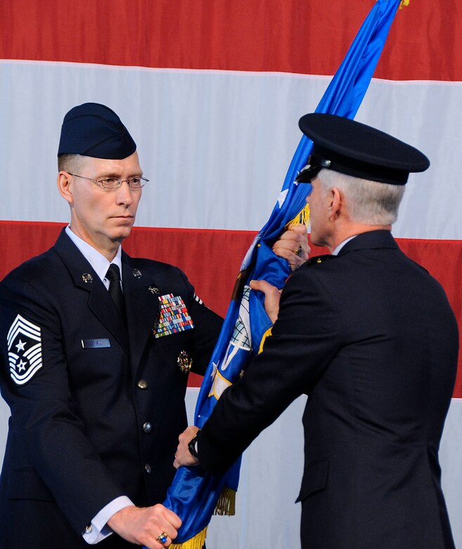 Gen. William L. Shelton receives the Air Force Space Command guidon from Chief Master Sgt. Richard T. Small, AFSPC Command Chief Master Sergeant, becoming the 15th commander of AFSPC during the change of command ceremony at Peterson Air Force Base, Colo. Jan. 5. (Air Force photo/Duncan Wood)
