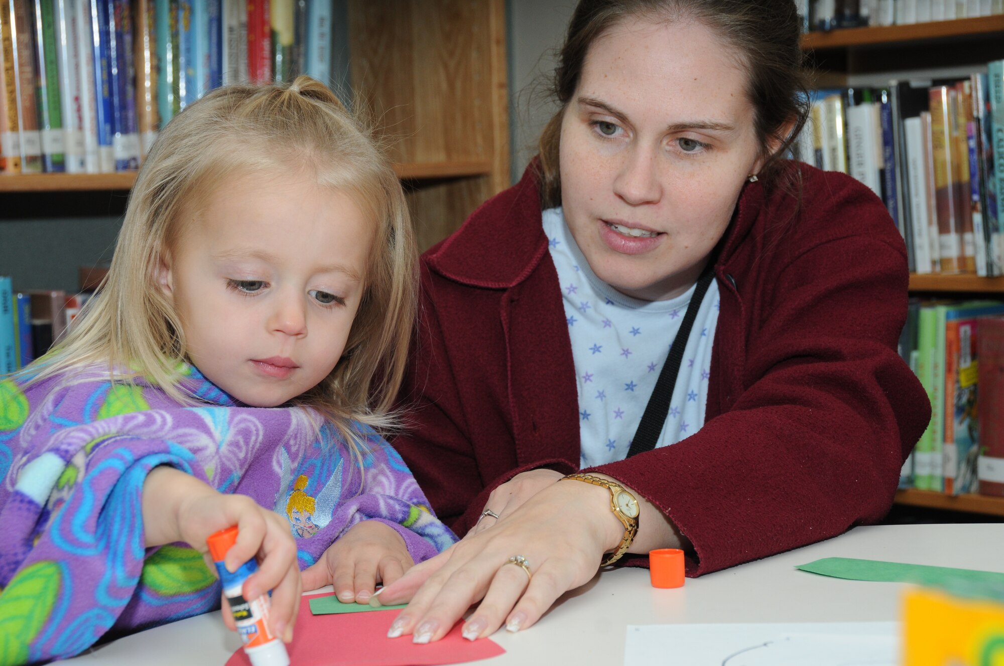 Three-year-old Aurora Mayo and her mom, Alyssa, assemble a Christmas stocking. Aurora’s dad is 2nd Lt. Robert Mayo, 333rd Training Squadron.  (U.S. Air Force photo by Kemberly Groue)