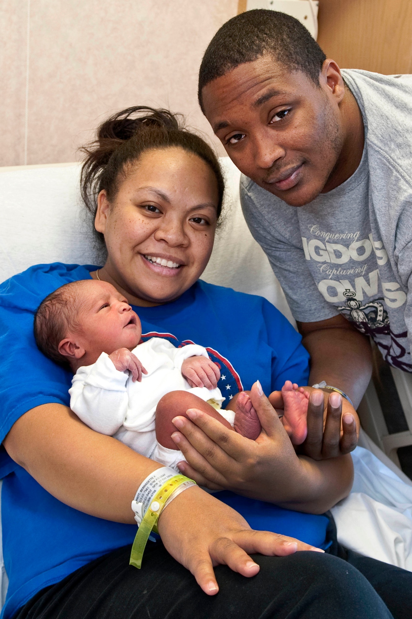 NELLIS AIR FORCE BASE, Nev.-Tech. Sgt. TJ Merritt, 57th Aircraft Maintenance Squadron weapons expeditor, and his wife, Bernadette, pose for a photo with their newborn son, Kamali'i, Jan. 4 at the Mike O'Callaghan Federal Hospital. Born Jan. 3 at 5:58 a.m., Kamali'i was the first child born at Nellis in 2011. (U.S. Air Force photo by Airman 1st Class George Goslin)
