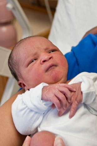 NELLIS AIR FORCE BASE, Nev.-Newborn Kamali'i Merritt looks up at his parents, Bernadette and Tech. Sgt. TJ Merritt, 57th Aircraft Maintenance Squadron weapons expeditor, Jan. 4 in their hospital room at the Mike O'Callaghan Federal Hospital. Born Jan. 3 at 5:58 a.m., Kamali'i was the first child born at Nellis in 2011. (U.S. Air Force photo by Airman 1st Class George Goslin)