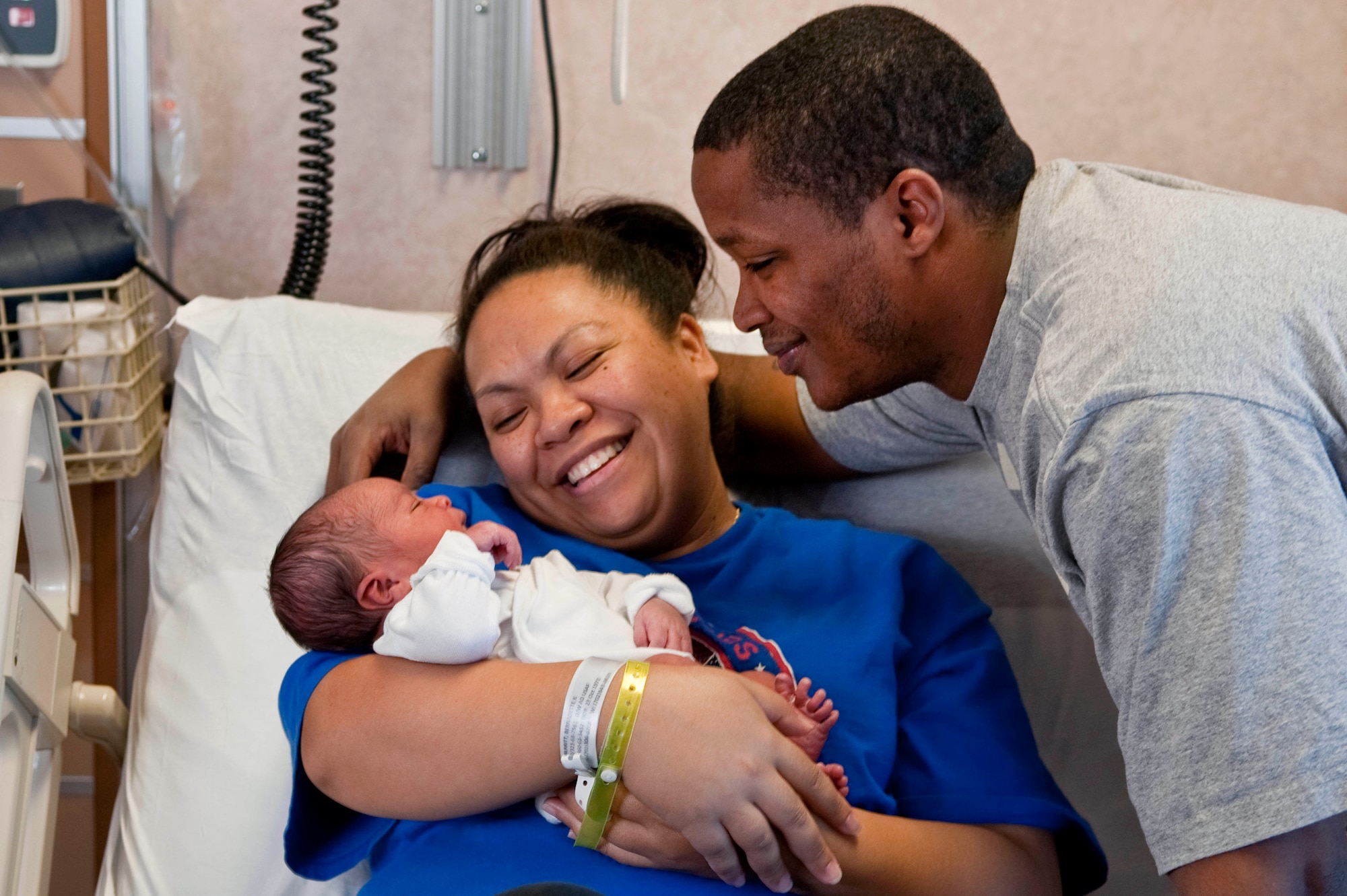 NELLIS AIR FORCE BASE, Nev.-Tech. Sgt. TJ Merritt, 57th Aircraft Maintenance Squadron weapons expeditor, and his wife, Bernadette, smile at their newborn son, Kamali'i, Jan. 4 at the Mike O'Callaghan Federal Hospital. Born Jan. 3 at 5:58 a.m., Kamali'i was the first child born at Nellis in 2011. (U.S. Air Force photo by Airman 1st Class George Goslin)