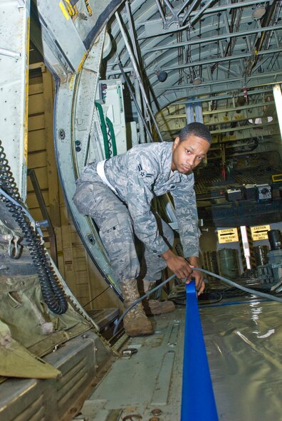 Airman 1st Class Otez McSpadden, a 19th Equipment Maintenance Squadron aircraft structural maintenance journeyman, tapes down protective foil Jan. 5, 2011, at Little Rock Air Force Base, Ark., prior to the sanding and painting steps of the refurbishment process. Airmen from the squadron’s C-130 refurbishment section are in the business of reviving Air Mobility Command’s aging fleet of C-130s. (U.S. Air Force Photo/Staff Sgt. Nestor Cruz)
