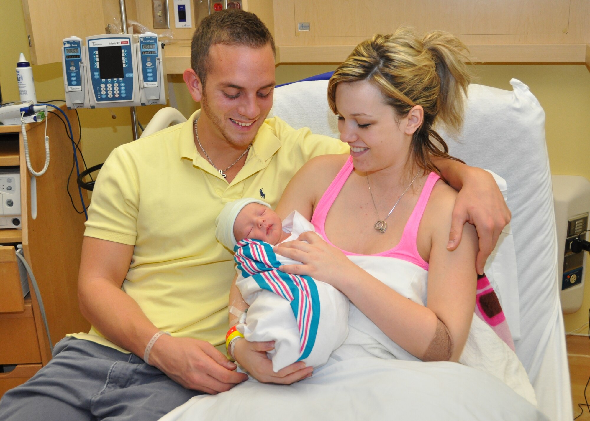 Airman 1st Class Sean and Ashley Ives hold their son, Brady, in the 81st Medical Group Hospital’s family birthing center Monday. Brady, Keesler’s first baby for 2011, was born at 3:39 p.m. Sunday. He weighed 7 pounds, 3 ounces and was 18 ¾ inches “tall.” Airman Ives, from San Antonio, is a weather student in the 335th Training Squadron. Ashley is from Merritt Island, Fla. The first-time parents live on base.  (U.S. Air Force photos by Steve Pivnick)