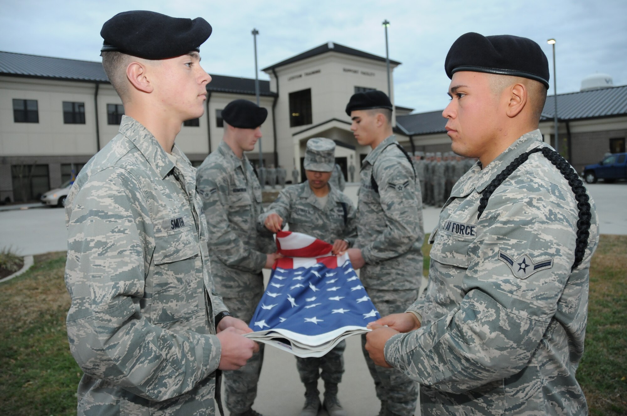 From left, Airman Basic Dillon Smith, Airman 1st Class William Edmondson, Staff Sgt.
Amay Odtohan, Airman 1st Class Jason George and Airman Mikhail Reyna-Maynez, 338th Training Squadron, fold the flag Dec. 15 at the 81st Training Group’s final retreat of 2010.  The Airmen are students and Sergeant Odtohan is a military training leader. Keesler plans to celebrate its 70th anniversary this year with a variety of events, including an open house and air show March 19-20.  (U.S. Air Force photo by Kemberly Groue)