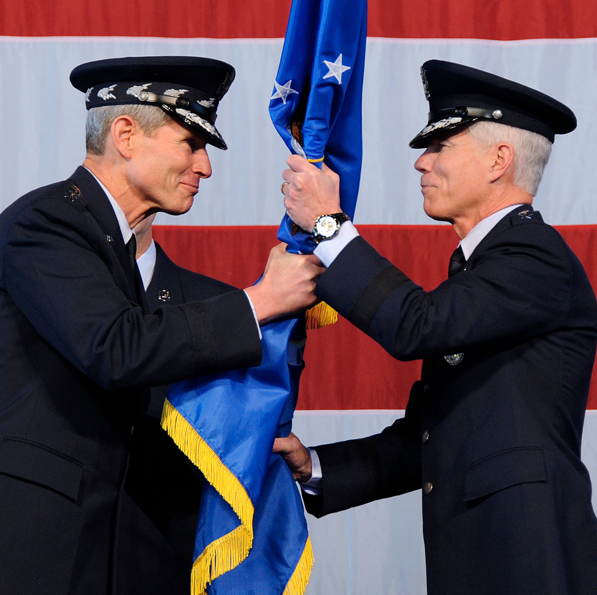 Air Force Chief of Staff Gen. Norton Schwartz (left) hands the Air Force Space Command flag to Gen. William Shelton (right) as he becomes the 15th commander of AFSPC in a ceremony Jan. 5 at Peterson Air Force Base, Colo. (U.S. Air Force photo by Duncan Wood)
