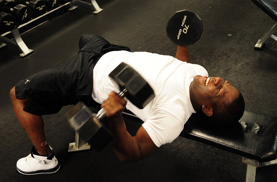 MOODY AIR FORCE BASE, Ga. -- Senior Airman Kenneth Bailey, 23rd Communications Squadron client support technician, uses free weights to workout Jan. 5.  The bench press is a weight training exercise for building the chest, shoulders and arms. (U.S. Air Force photo/Senior Airman Stephanie Mancha)(RELEASED)