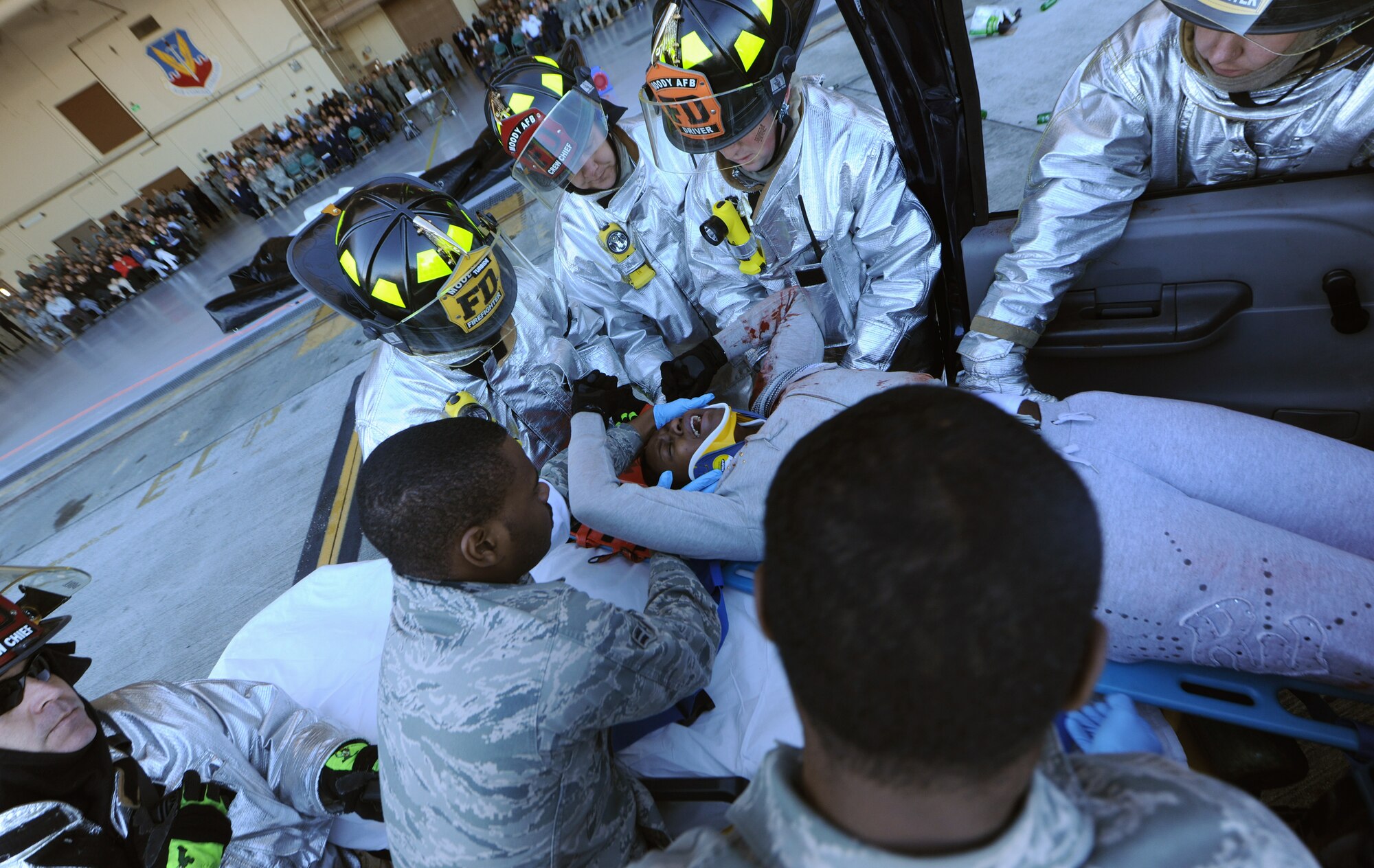 MOODY AIR FORCE BASE, Ga.-- Emergency response personnel pull Staff Sgt. Tia Taylor, 23rd Security Forces Squadron electronic  security systems NCO in charge, from a wrecked vehicle during the Wing Safety Day Jan.3. Members from the 23rd Wing were able to see how emergency response personnel respond to accidents during a demonstration hosted by the 23rd WG Safety office. (U.S. Air Force photo/Airman 1st Class Benjamin Wiseman)(RELEASED)