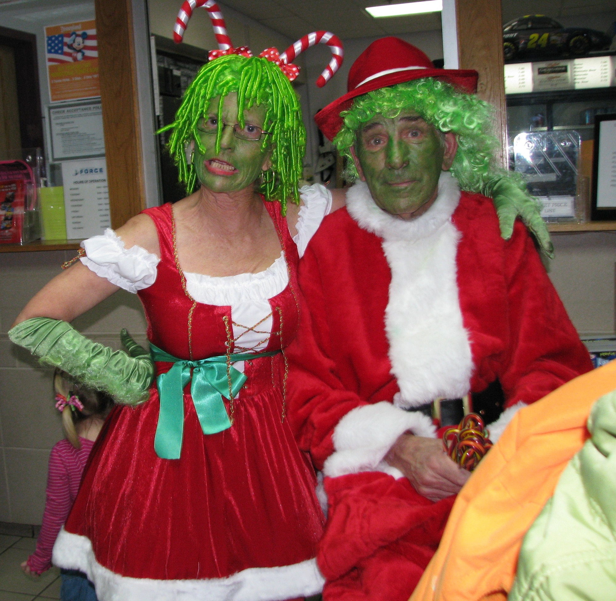 Mr. & Mrs. Grinch, aka Phyllis and David Gonda of Palmdale, Calif., take a moment to relax during the base-wide holiday party and pose for a photo. The Gondas began raising money to support a holiday celebration and bring gifts for all the children whose parents are stationed at Edwards. Each year they raise more than $10,000 to support the effort and say it's their way of giving back to America's men and women in uniform who are serving the country. (Air Force photo by Diane Betzler)
