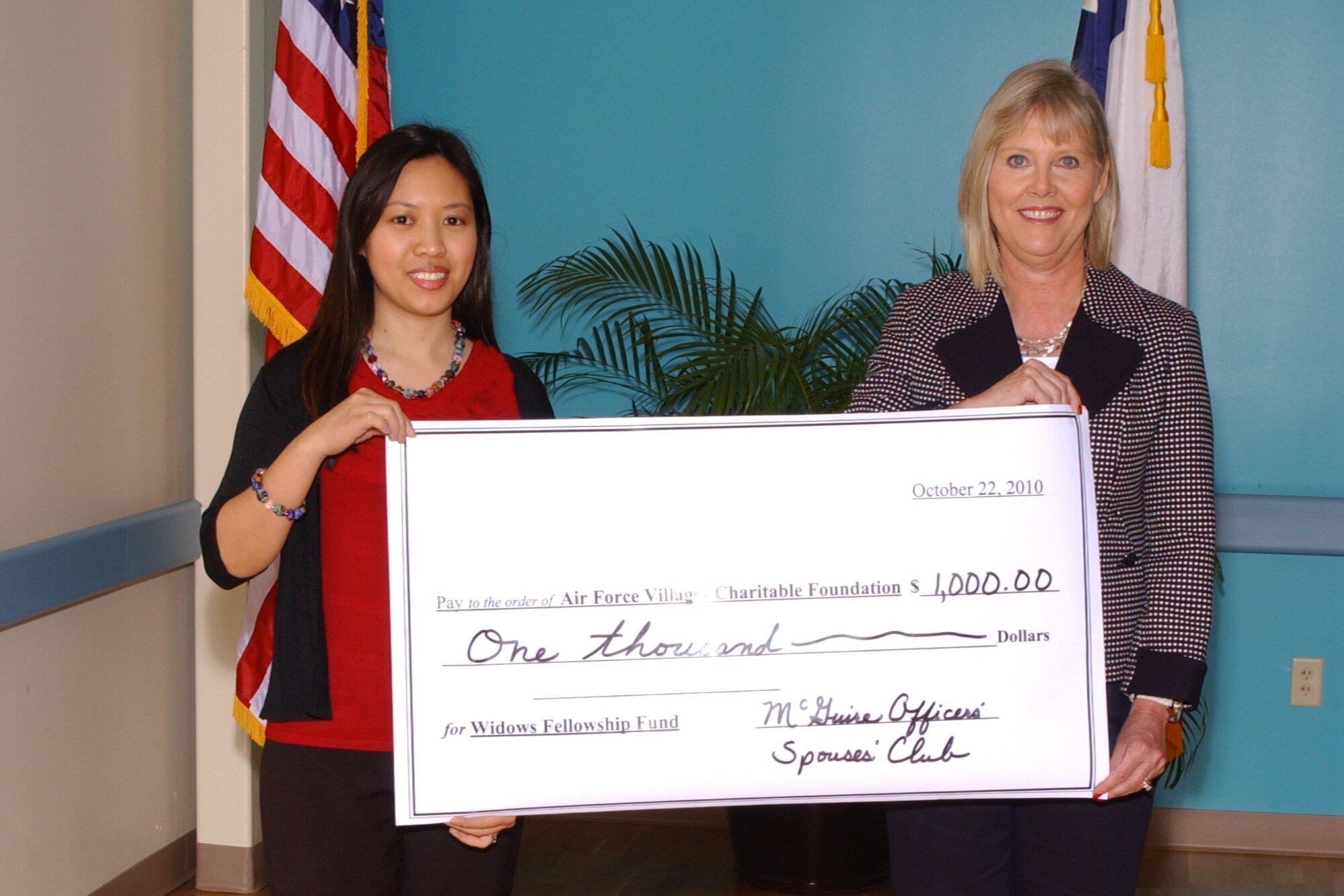 Marianne Fontilla, member of the McGuire Officers’ Spouses’ Club, right, and Suzie Schwartz, spouse of Air Force Chief of Staff, Gen. Norton Schwartz, display a giant check for the sum of $1,000 donated to the Air Force Village at the 46th Annual Meeting held at San Antonio, Texas, Oct. 22. (Courtesy photo) 