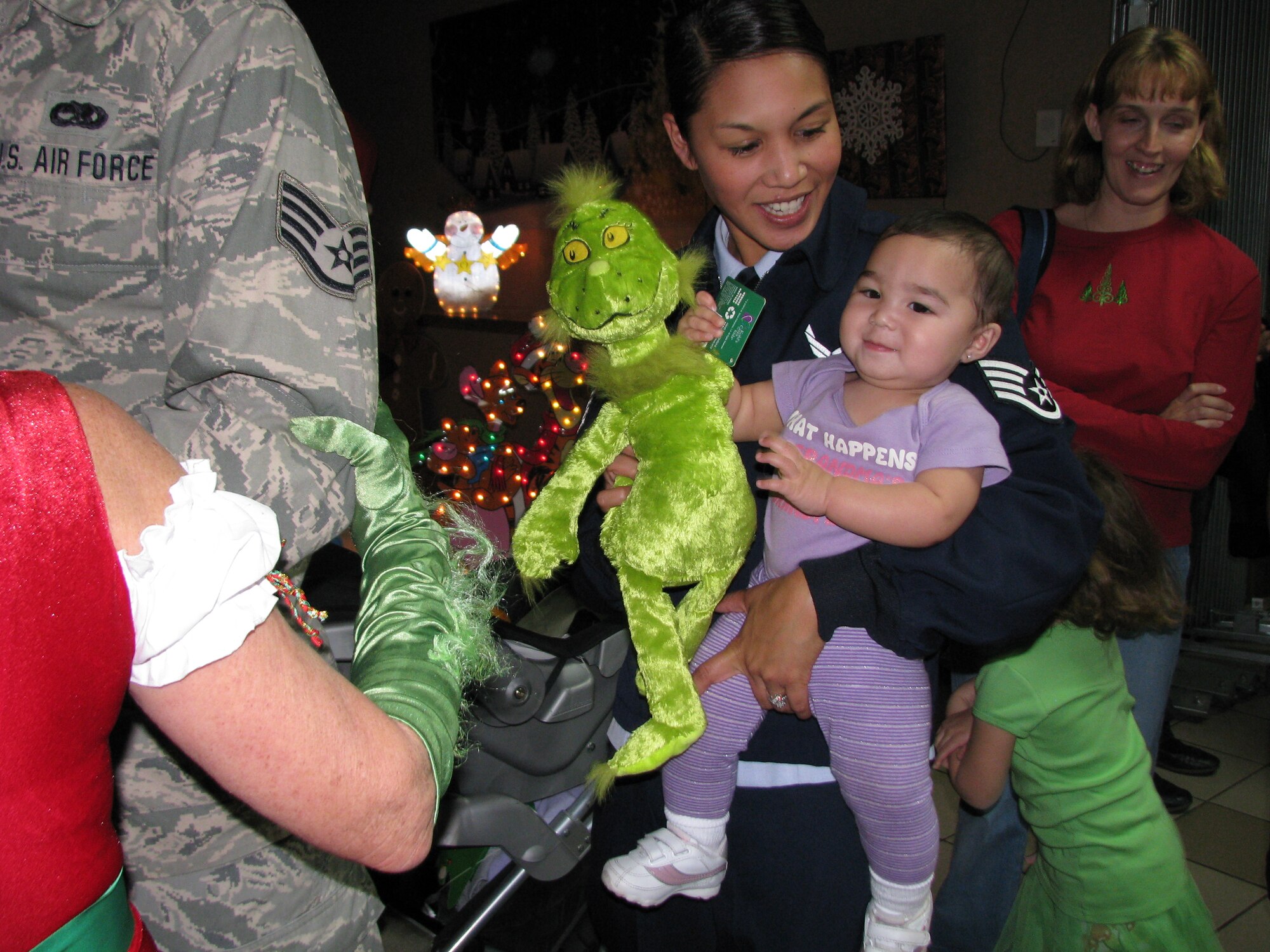 Staff Sgt. Melody Garcie and her 8-month-old daughter Kai, line up to visit Santa at the year-end base-wide holiday party. (Air Force photo by Diane Betzler)