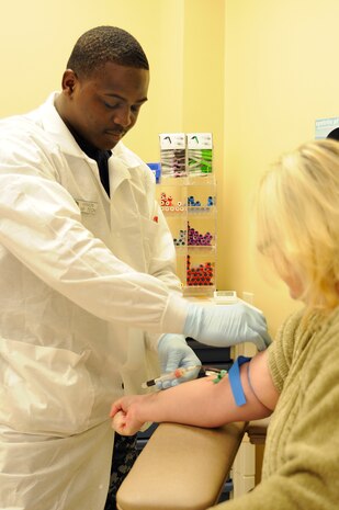 Hospital Corpsman 3rd Class Kendrick Minion collects a vial of blood for lab testing froma patient at Naval Health CLinic Charleston, Jan. 4. HM3 Minion, from Buena Vista, GA., works at the NHCC lab where more than 200 patients are seen each day and approximately 600 vials of blood are collected daily. (Photo by Mass Communications Specialist First Class Jennifer R. Hudson)