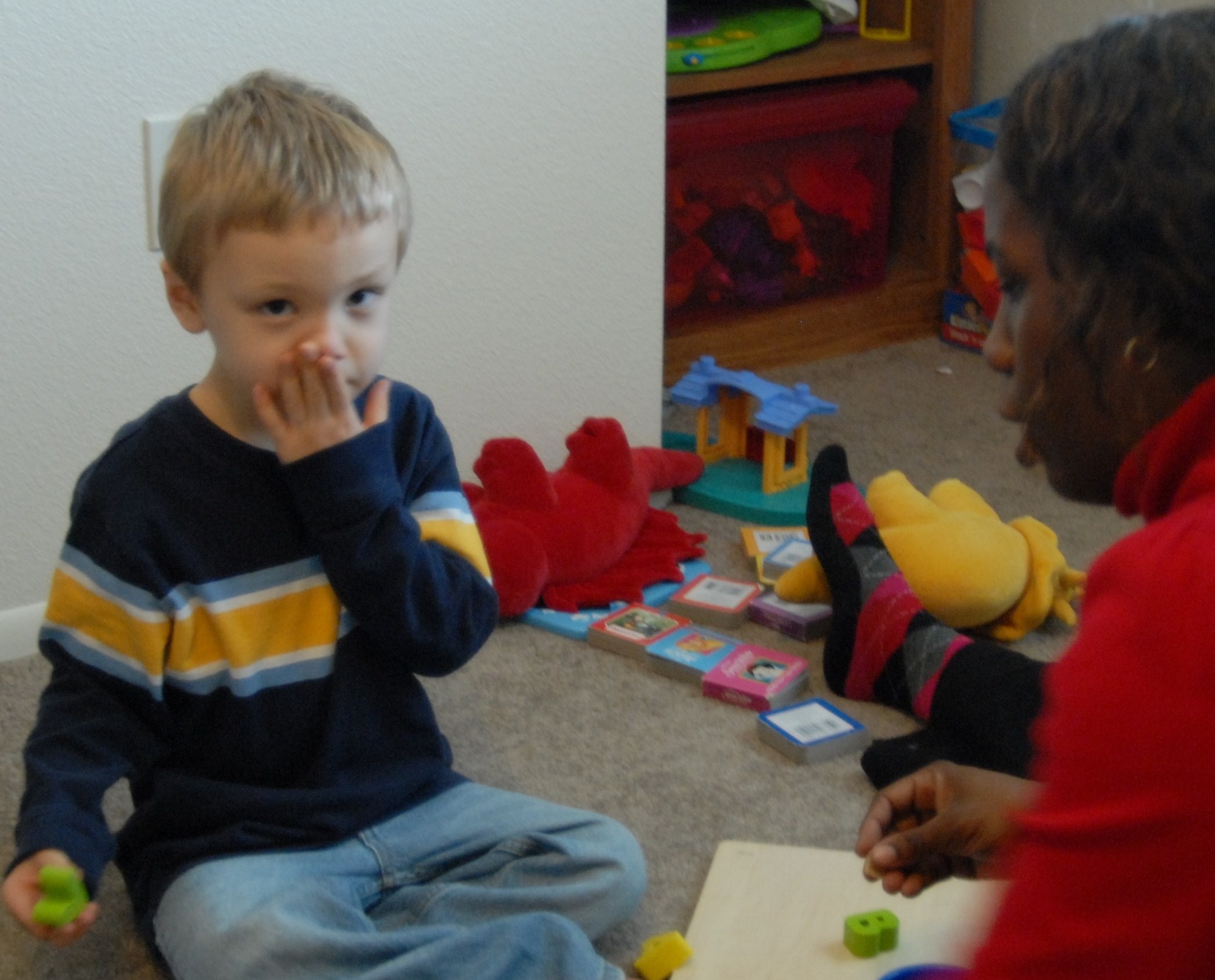 Caleb Maki, 4, works with Lisa Haynes, behavioral therapist at Wellspring, to identify the letters A and B as part of a therapy program designed to treat autism spectrum disorder. The Wellspring agency offers in-home therapy, which is covered by TRICARE, to families coping with autism in the Air Force’s Exceptional Family Member Program. (Air Force photo by Kate Blais)