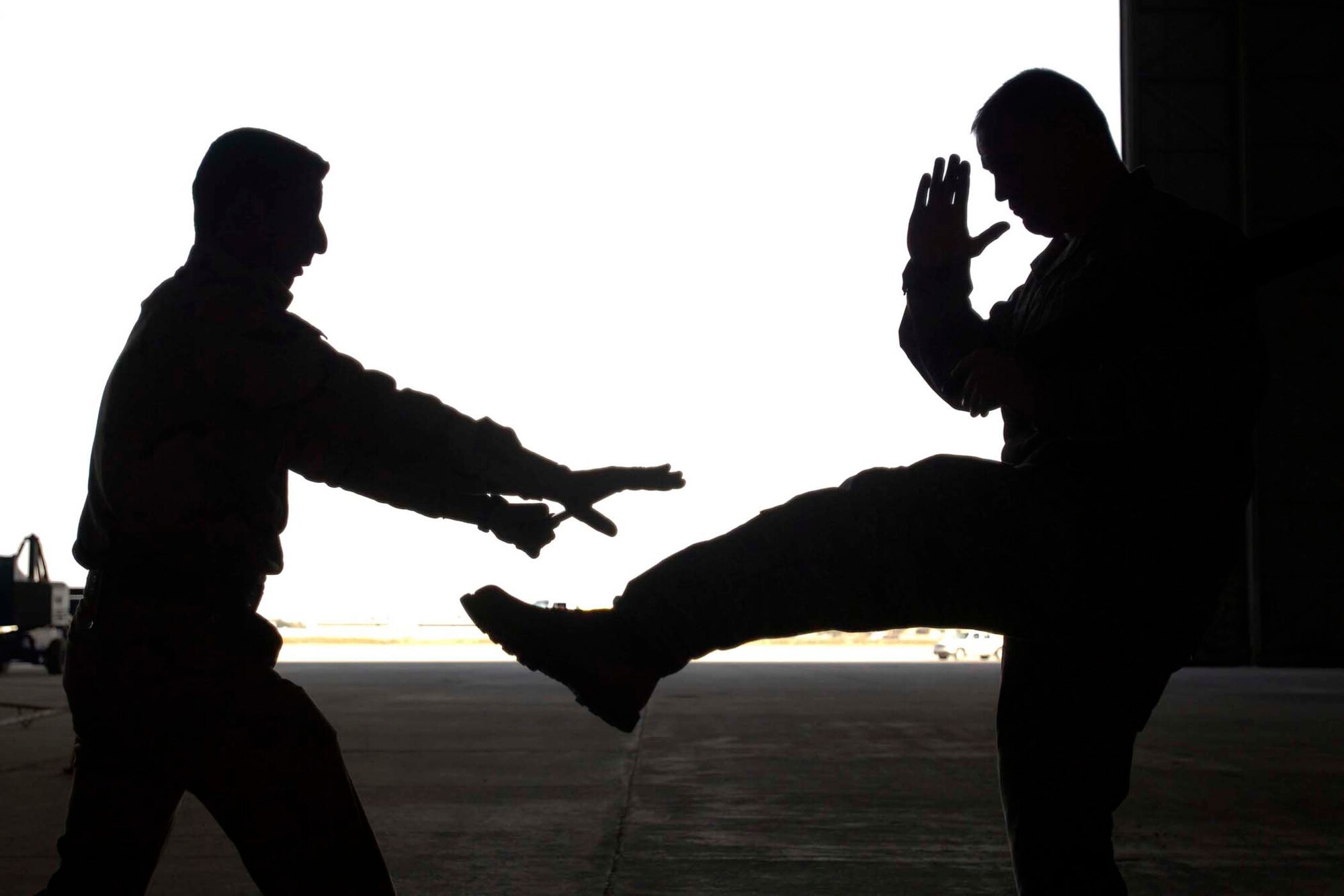 Staff Sgt. Timothy DeTerra attempts to kick an Iraqi air force airmen Dec. 23, 2010, during a training session. This training is the first of its kind held at New Al-Muthana Air Base, Iraq, and promises to help the Iraqi air force build a reliable and secure force in the year ahead. Sergeant DeTerra is a New Al-Muthana Air Base Transition Team member. (U.S. Air Force photo/Tech. Sgt. Randy Redman) 