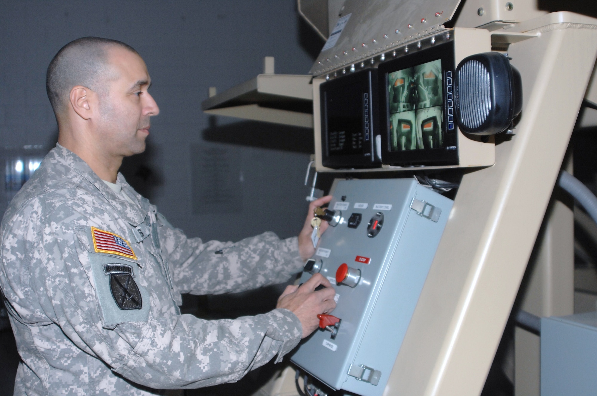 Master Sgt. Rene Sales instructor and training developer for Joint Training and Training Development Center watches the cabin of the MRAP Egress Trainer. The new mine resistant armor protected vehicle egress trainer was brought to Joint Base McGuire-Dix-Lakehurst to benefit servicemembers the Joint Training and Training Development Center Dec. 9. (U.S. Army photo/Spc. Saul Rosa)