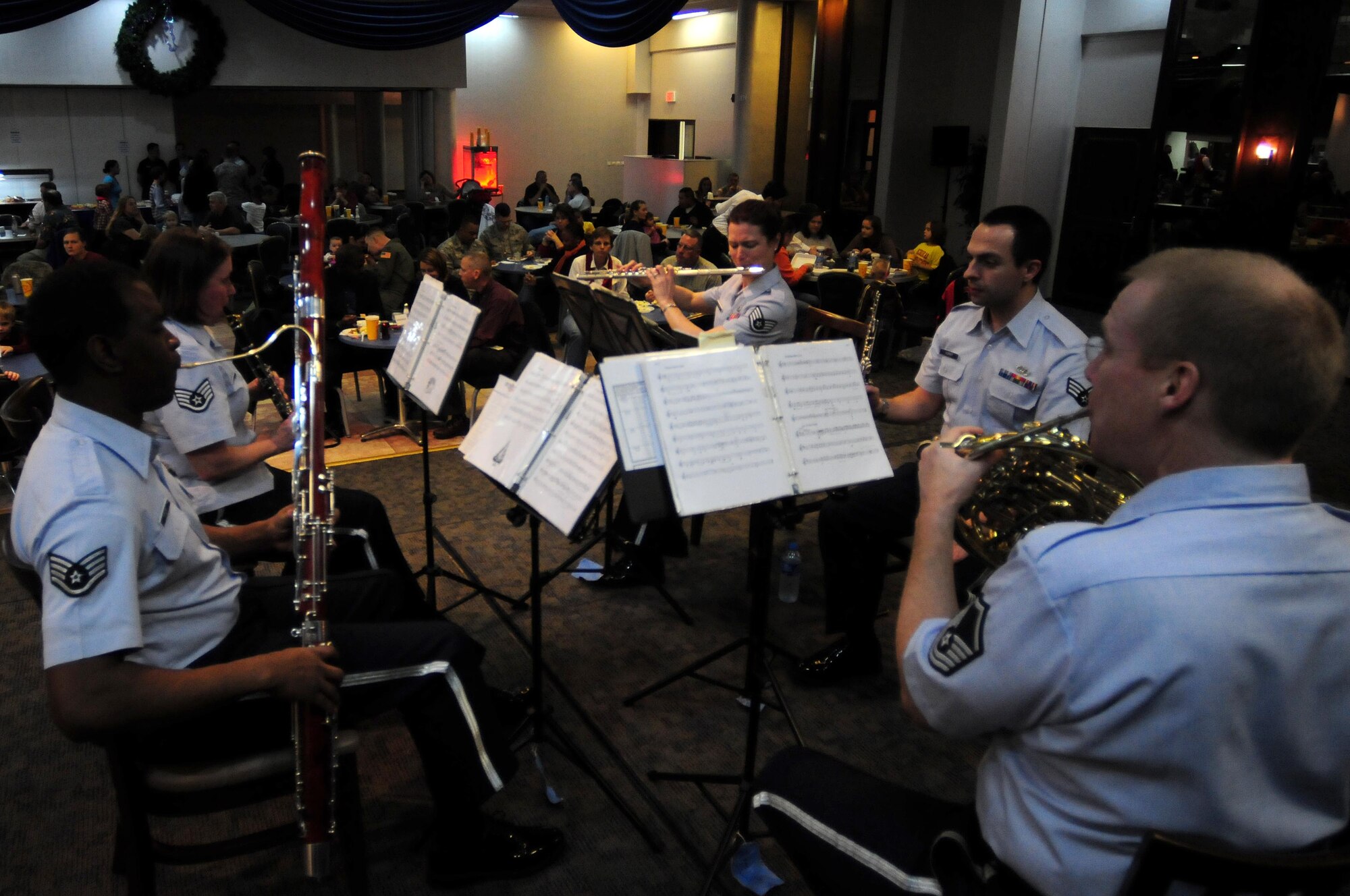 Winds Aloft Woodwind Quintet, a premier component of the USAFE Band, performs for family members at the Consolidated Club Dec. 17, 2010 at Incirlik Air Base, Turkey.  Winds Aloft, a five-member ensemble from the USAFE band, visited Incirlik to spread holiday cheer to Airmen and their families.  (U.S. Air Force photo by Senior Airman Ashley Wood/Released)