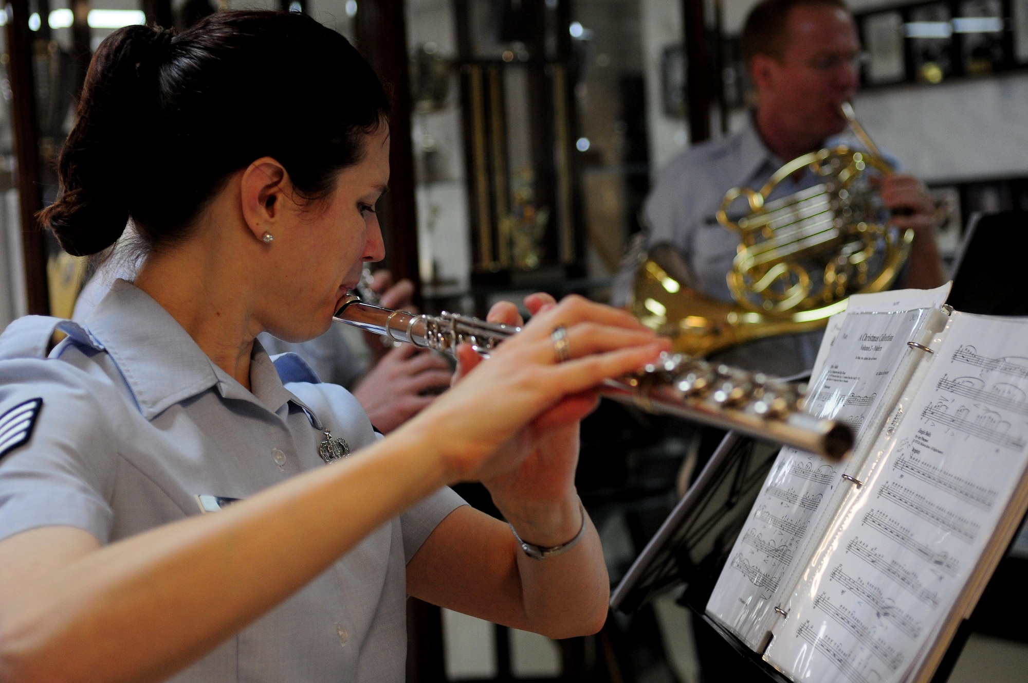 Staff Sgt. Avril Claytor, Winds Aloft flute player, entertains Incirlik personnel at the wing headquarters building Dec. 16, 2010, at Incirlik Air Base, Turkey.  Winds Aloft, a five-member ensemble from the USAFE band, visited Incirlik to spread holiday cheer to Airmen and their families.  (U.S. Air Force photo by Senior Airman Ashley Wood/Released)
