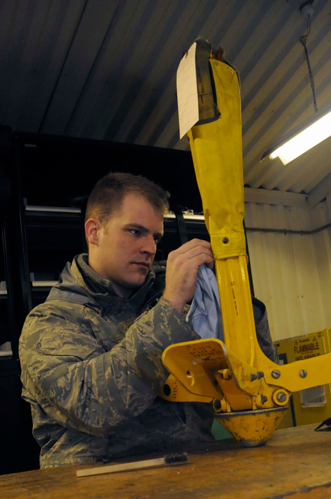 Senior Airman Jacob Widner, 748th Aircraft Maintenance Squadron mobility equipment/Dash 21 technician, details a forest penetrator at the 56th Helicopter Maintenance Unit support building Jan. 5. Airman Widner was nominated for a Liberty Spotlight because he portrays the core value 'Excellence in All We Do.' (U.S Air Force photo/Airman 1st Class Eboni Reams) 