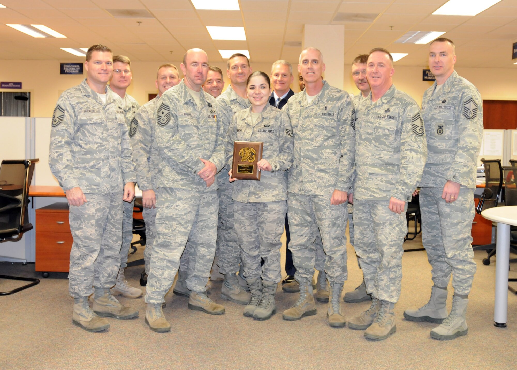 Staff Sgt. Lizzette G. Simmons, 31st Force Support Squadron Military Personnel Section career development representative, is presented Jan. 5 the Aviano Chiefs' Choice Award for November 2010 by the Aviano's Chiefs Group. Aviano chiefs present the Chiefs' Choice Award monthly to an Airman who clearly exceeds Air Force Standards in the areas of dress and appearance, bearing and exceptional behavior in performance of their duties and in relationships with others. (U.S. Air Force photo/Staff Sgt. Mercedeskimble L. Crossland)