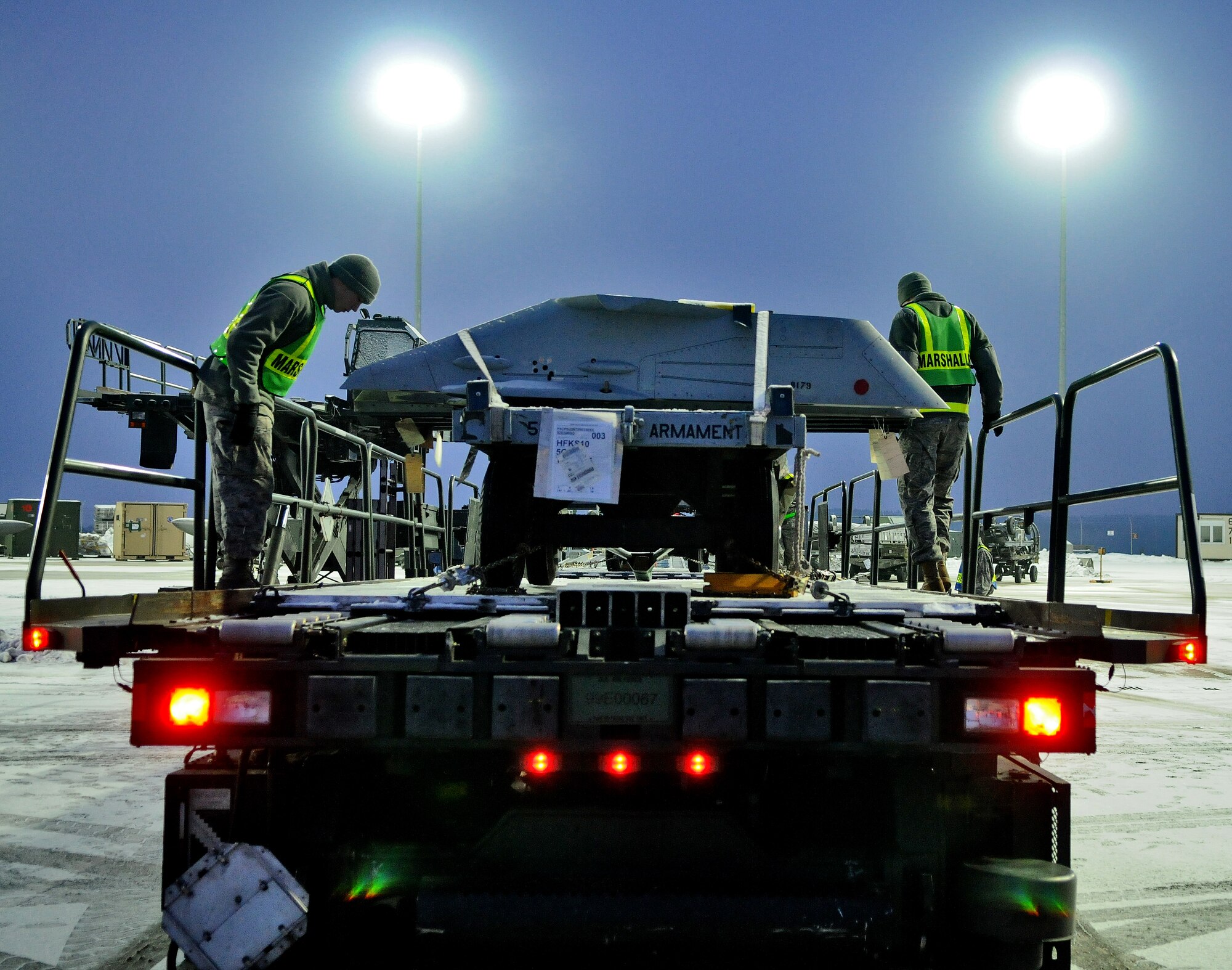 SPANGDAHLEM AIR BASE, Germany – Airman Zach Edwards, 52nd Logistics Readiness Squadron air transportation journeyman, and Airman 1st Class Johnny Sanes, 52nd Logistics Readiness Squadron fuels journeyman, load cargo to a 60k Tunner  during a cargo upload process Jan. 5.  The cargo was flown to Nellis Air Force Base, Nev., to support the 480th Fighter Squadron during a Red Flag training exercise. The 480th FS will be participating in Red Flag from Jan. 22 – Feb.  4. (U.S. Air Force photo/Senior Airman Nick Wilson)