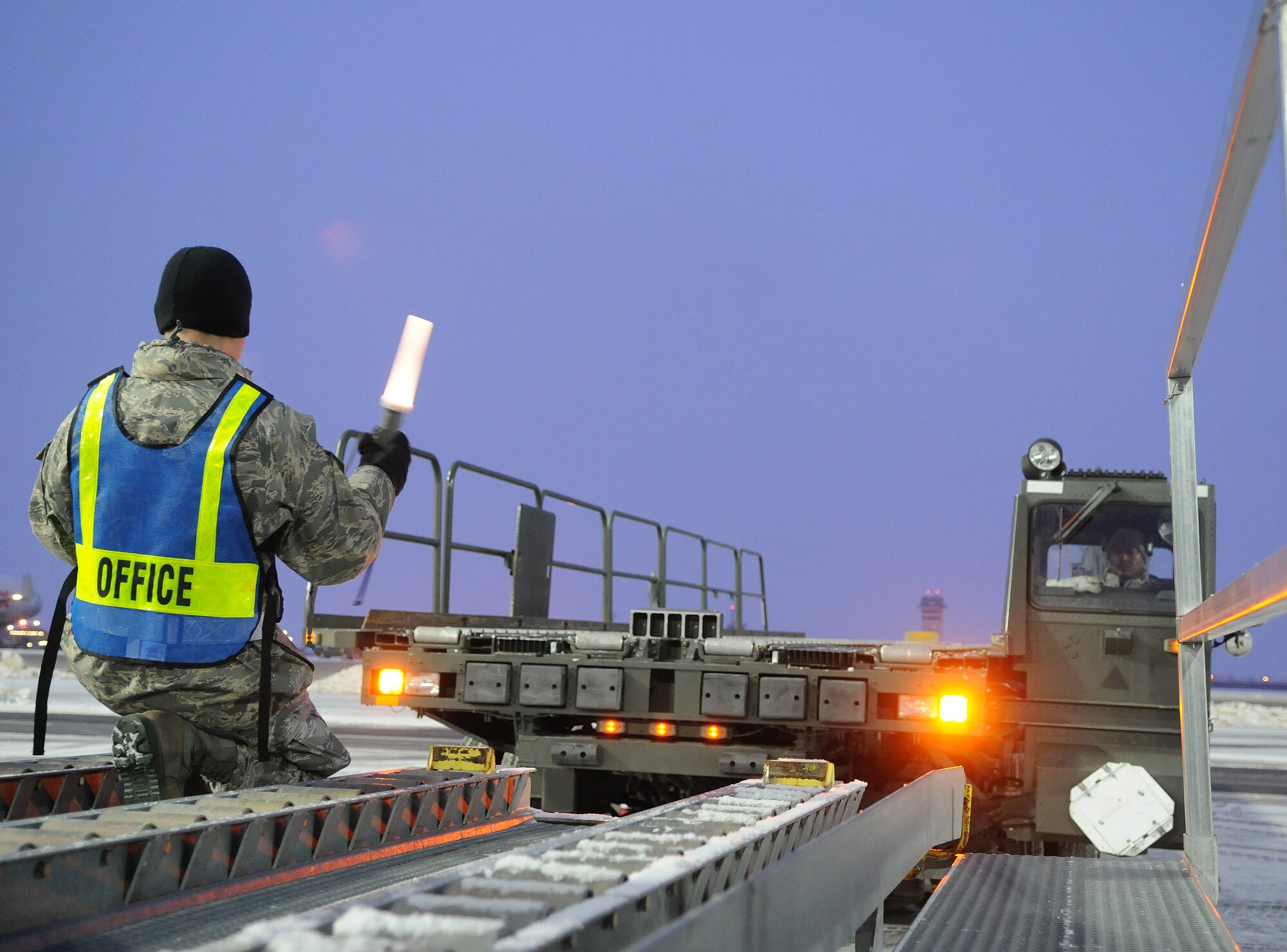 SPANGDAHLEM AIR BASE, Germany – Airman 1st Class Fredy Rios, 52nd Logistics Readiness Squadron hazardous materials pharmacy apprentice, marshalls a 60k Tunner  during a cargo upload process Jan. 5.  The cargo was flown to Nellis Air Force Base, Nevada, to support the 480th Fighter Squadron during a Red Flag training exercise. The 480th FS will be participating in Red Flag from Jan. 22 – Feb.  4. (U.S. Air Force photo/Senior Airman Nick Wilson)