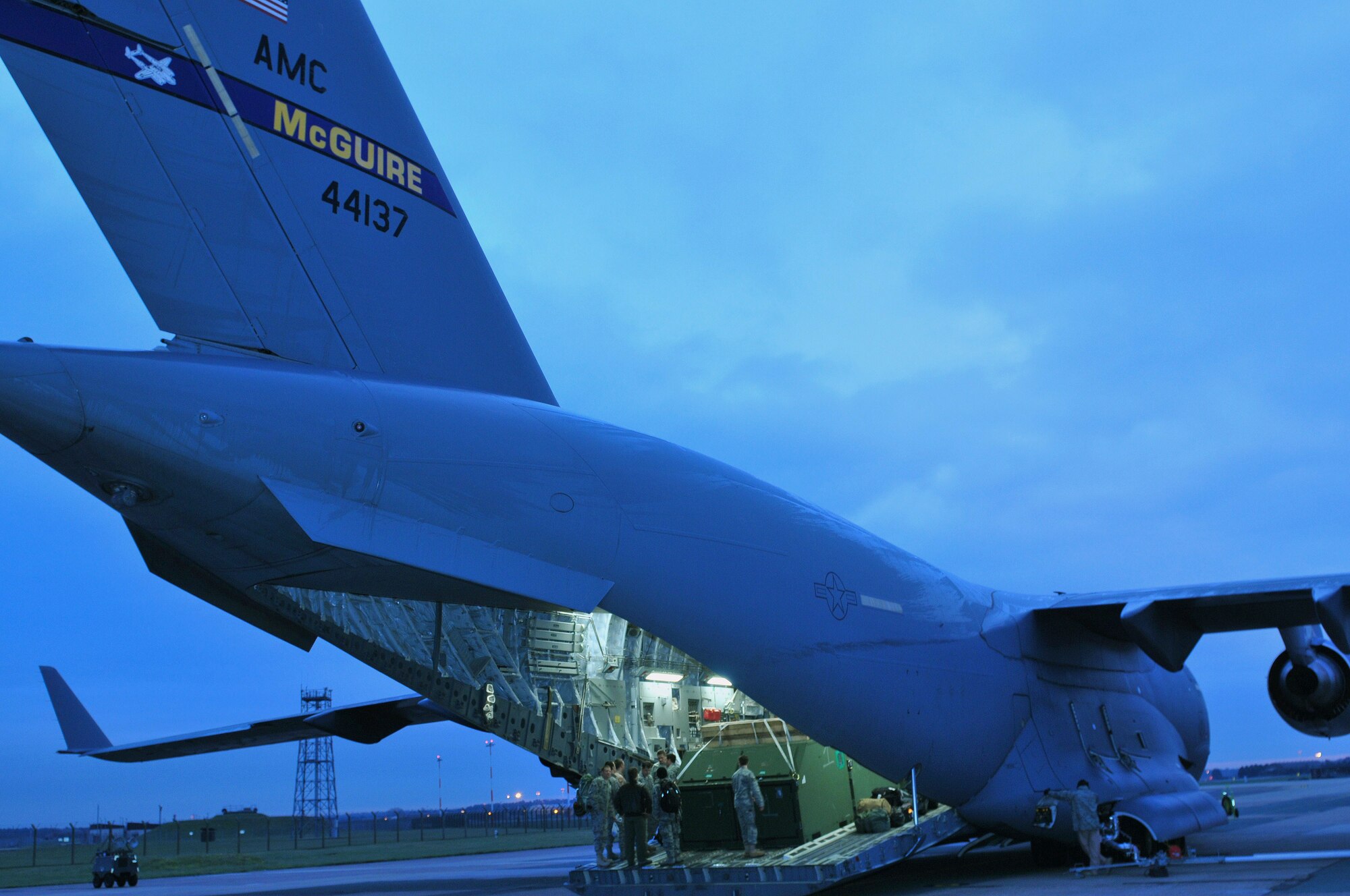 Pararescuemen from the 56th Rescue Squadron board a C-17 Globemaster for a deployment to Southwest Asia from RAF Lakenheath, England, Jan. 4. This team of pararescue jumpers will perform combat search and rescue missions in support of the Combined Forces Air Component commander. (U.S. Air Force photo by Staff Sgt. Connor Estes)